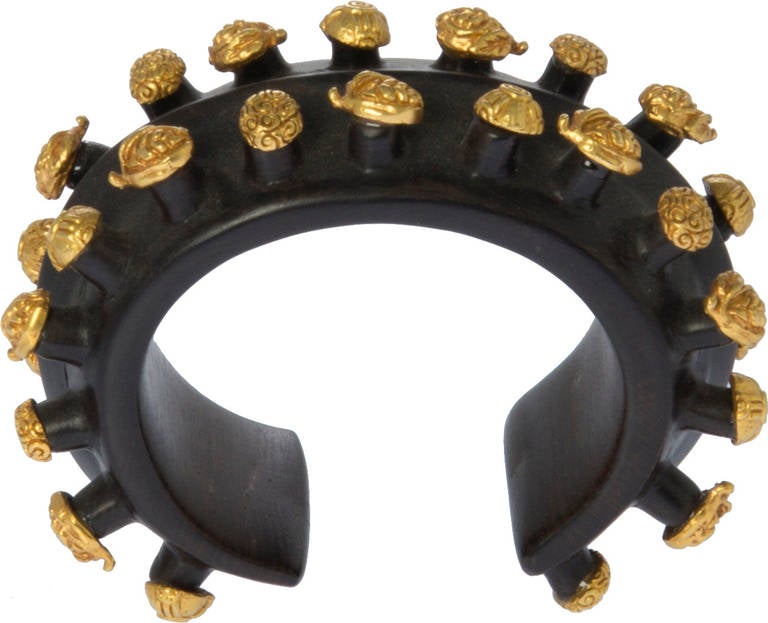 This is a fabulous bracelet love the studded gold gilt accents.
The interior circumference    is with an opening of        .