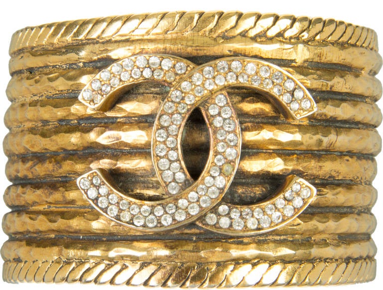 A fabulous statement making piece.  This gold gilt wide bracelet is accented with the CHANEL logo in crystals and a roped edging. 
Interior circumference: 7 3/8