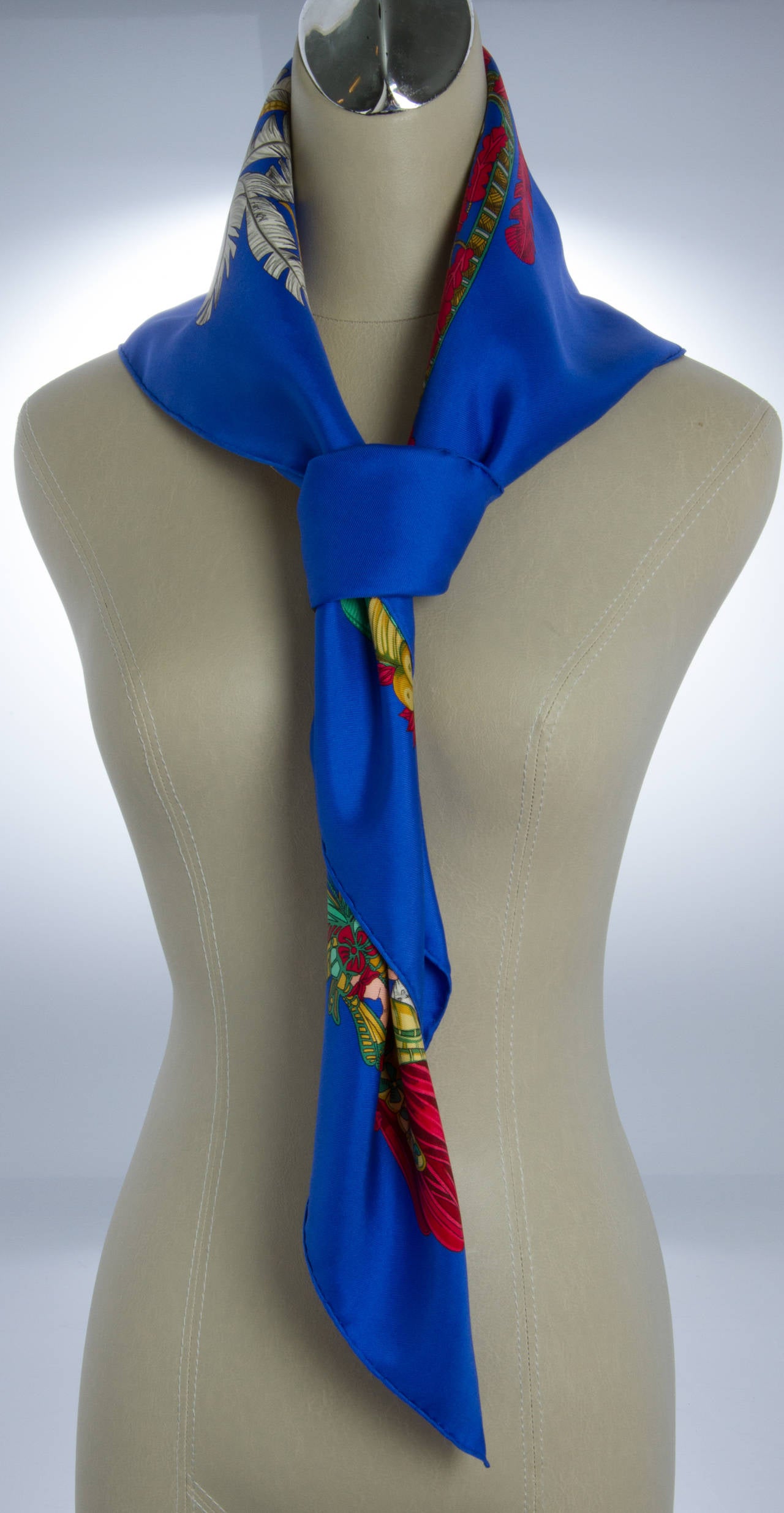 This scarf depicts powdered Baroque wigs, bonnets, and large plume feathers.