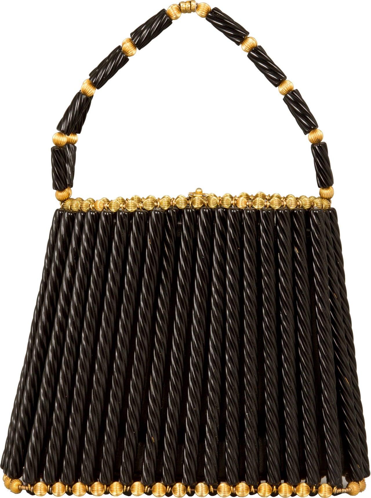 This is an interesting bag made of black licorice like elements accented with gilt beads. The interior lining is black is leather.
