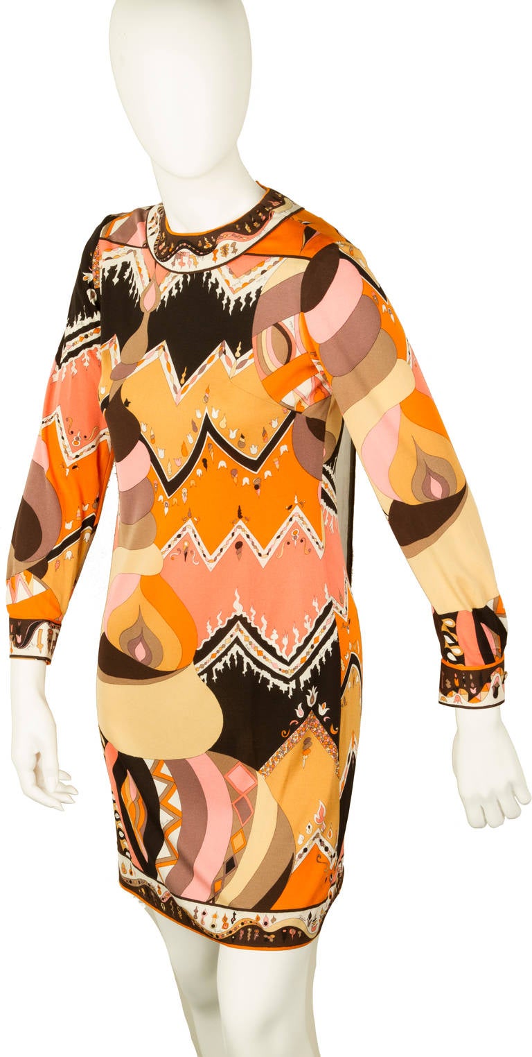 This is a mod Emilio Pucci Print Dress with a jewel neckline and quarter sleeves.
Labeled: Emilio Pucci and size 8.
Please look at the measurements as this is probably a smaller than todays size 8.

The shoulder seam to sleeve end is 22 1/2