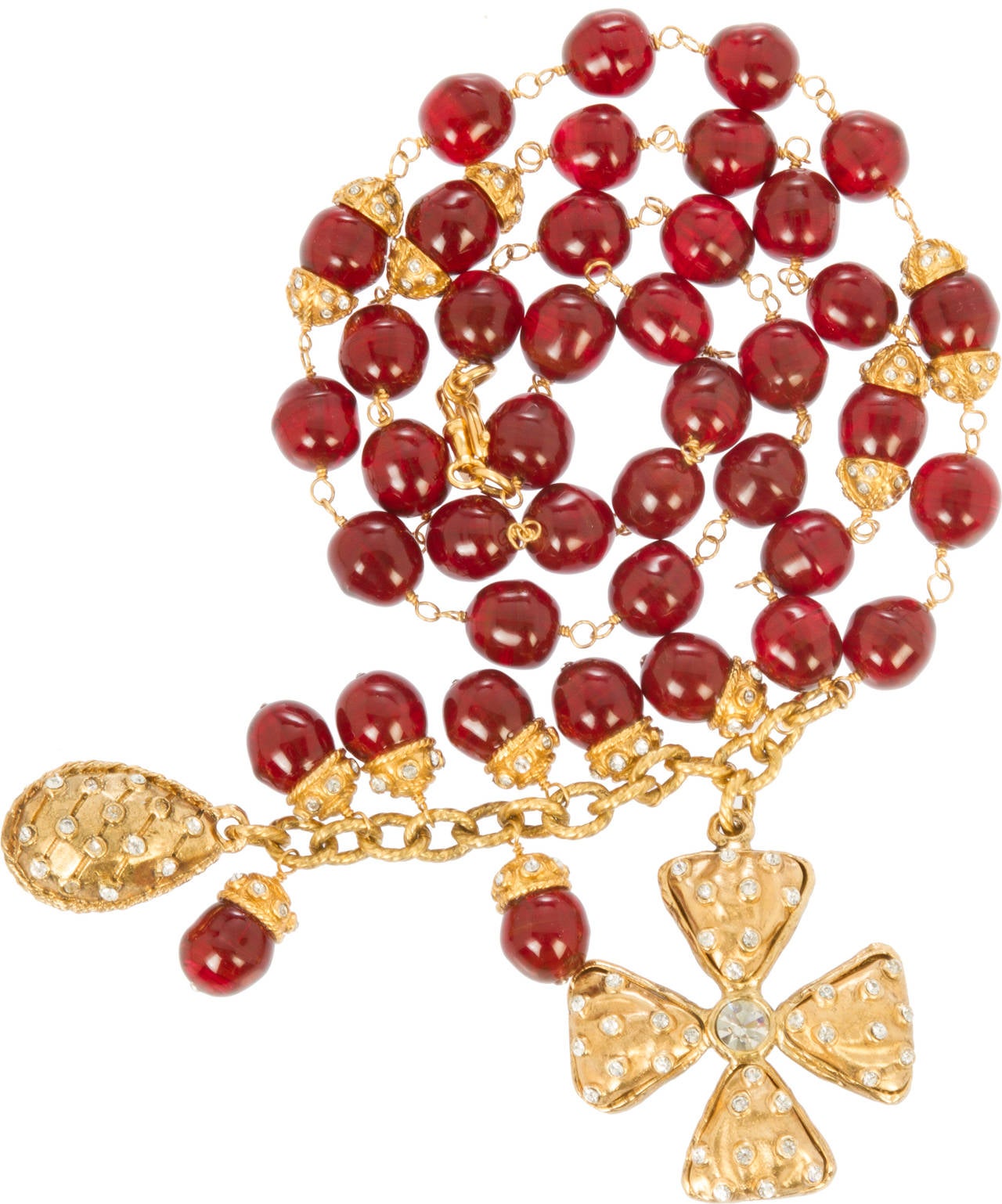 This beautiful necklace features gorgeous red gripoix glass beads and charms studded with crystals. The length of the necklace does not include the additional length of the charms.