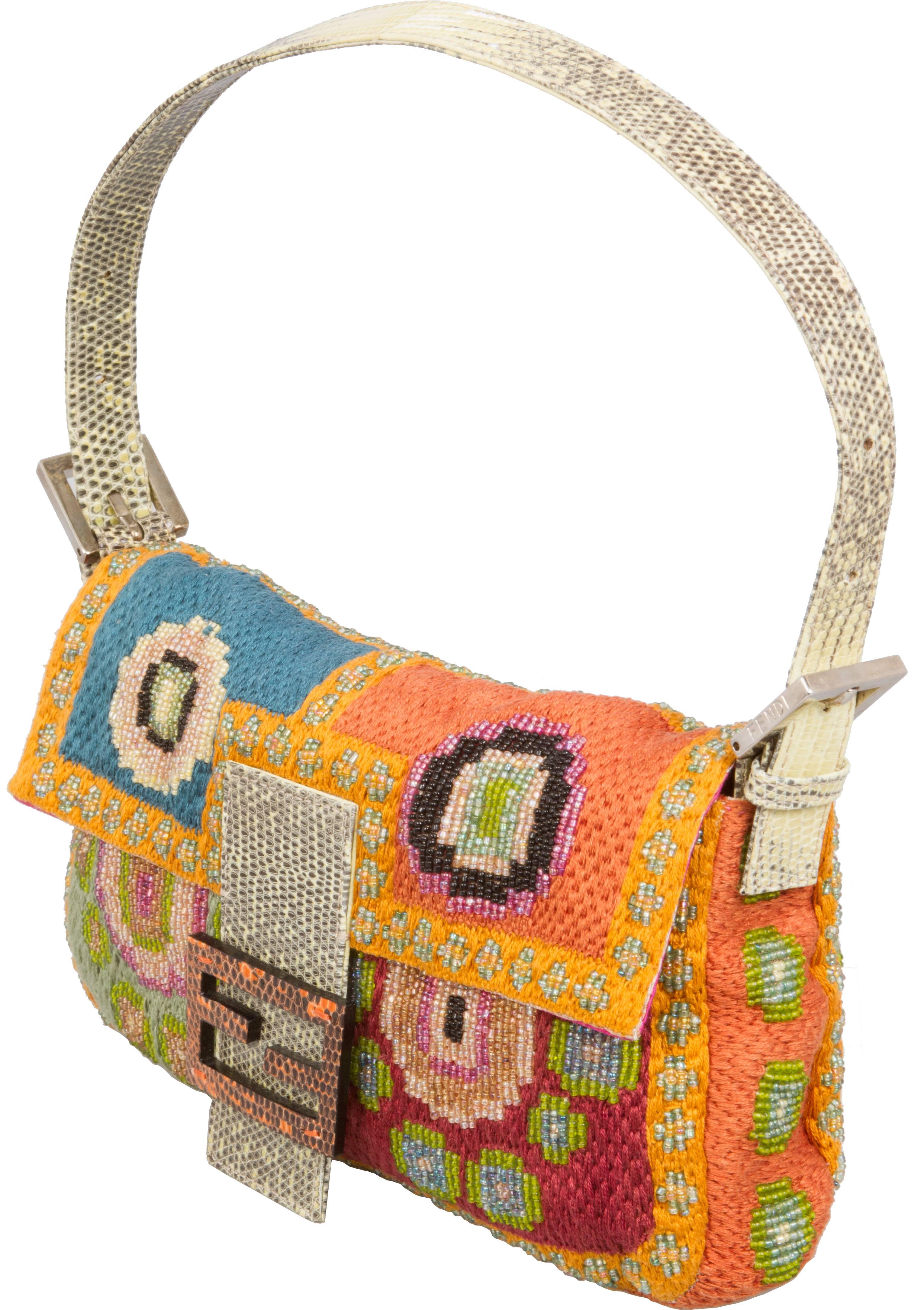 This fabulous runway bag from Fendi that has beaded flowers and a Fuscia lined interior with a lizard strap and closure.