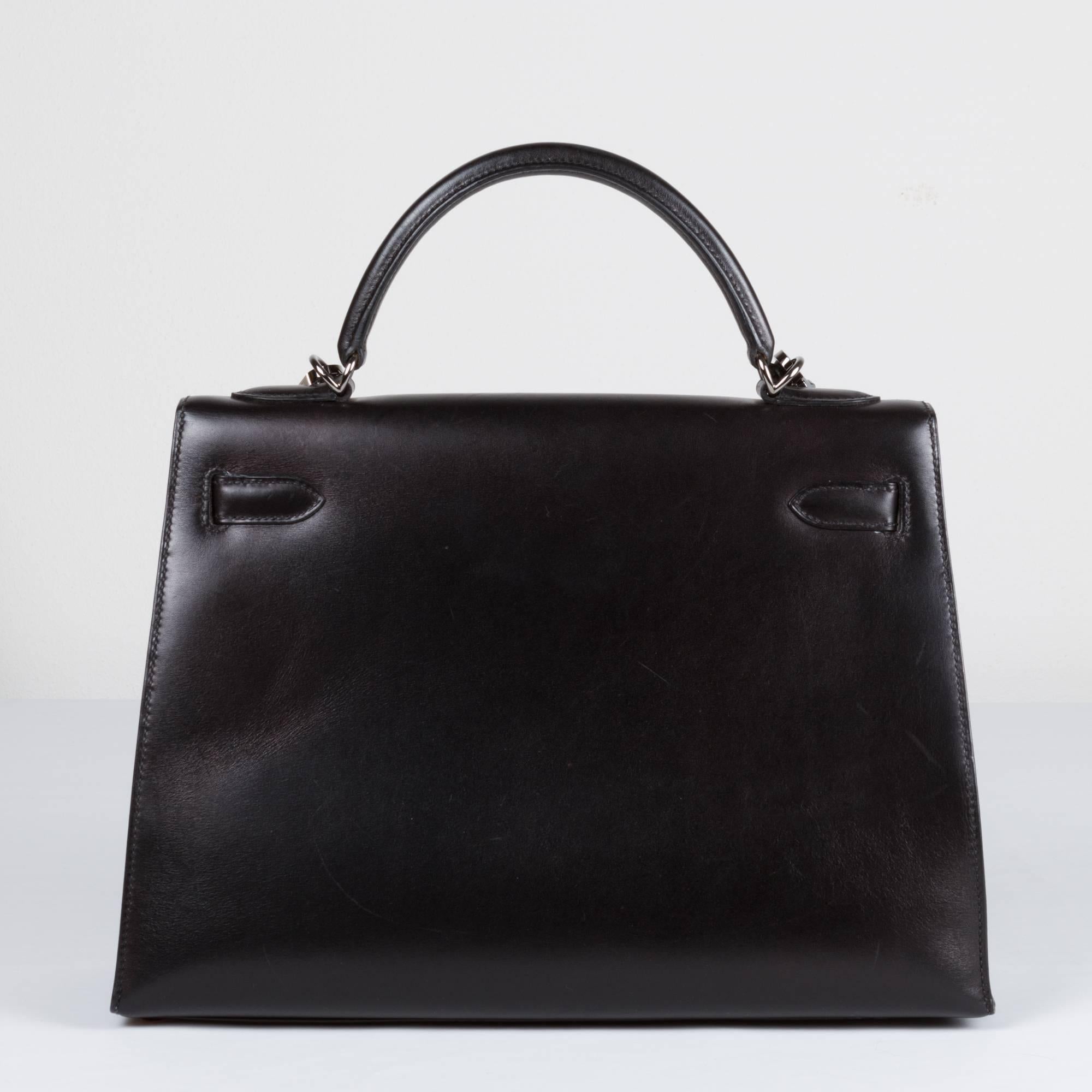 Kelly Hermés in black box.
Hardware in burnished silver.
The bag comes withoud padlock, but with dustbag, clochette and keys, and shoulderbelt.

