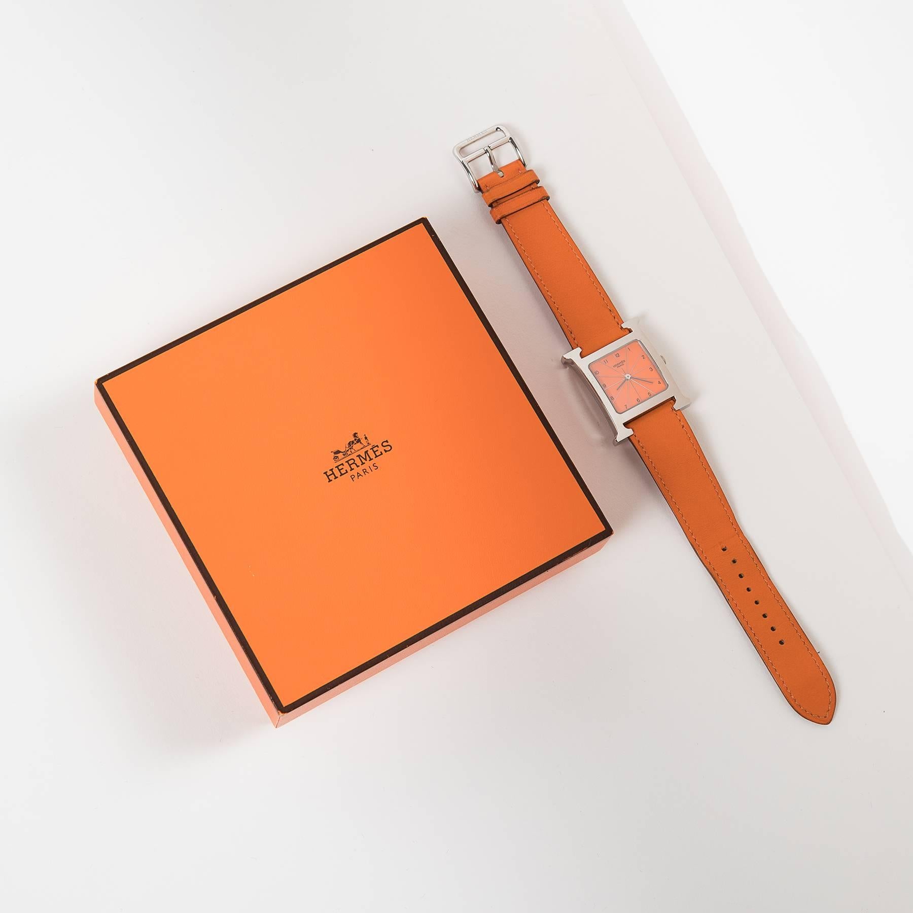 Hermes Heure H wrist watch.
Very good condition. Only light signs of wear. 
With original box and certificate.
Tangerine swift Wristband.
made in france.
