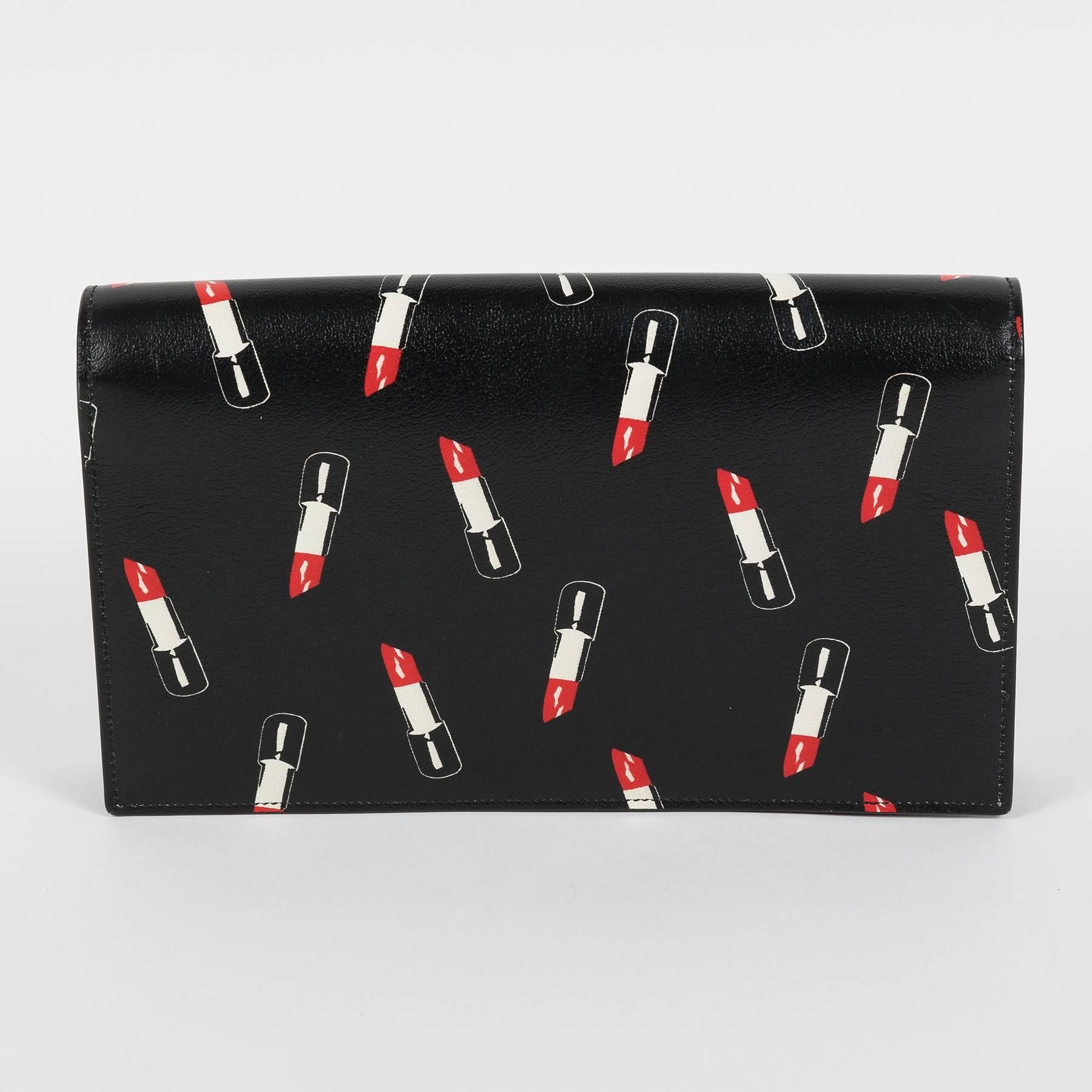 Yves Saint Laurent clutch. 
Collectible item with lipstick print.
With tag and dustbag.
New, never worn.
