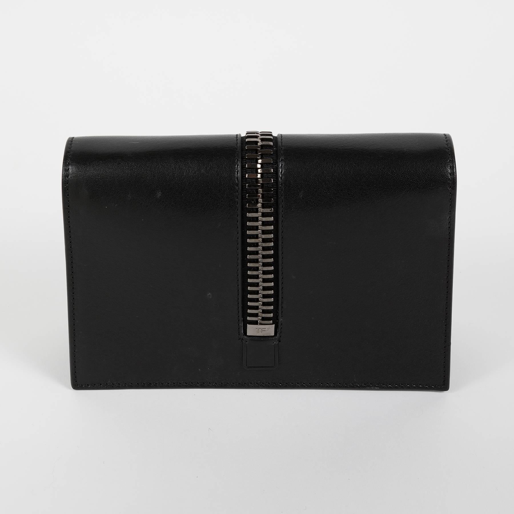 Tom Ford shoulder flap bag in black leather with a big decorative zipper on the flap.
The strap is removable.
The bag comes with its dustbag and  original tag.
