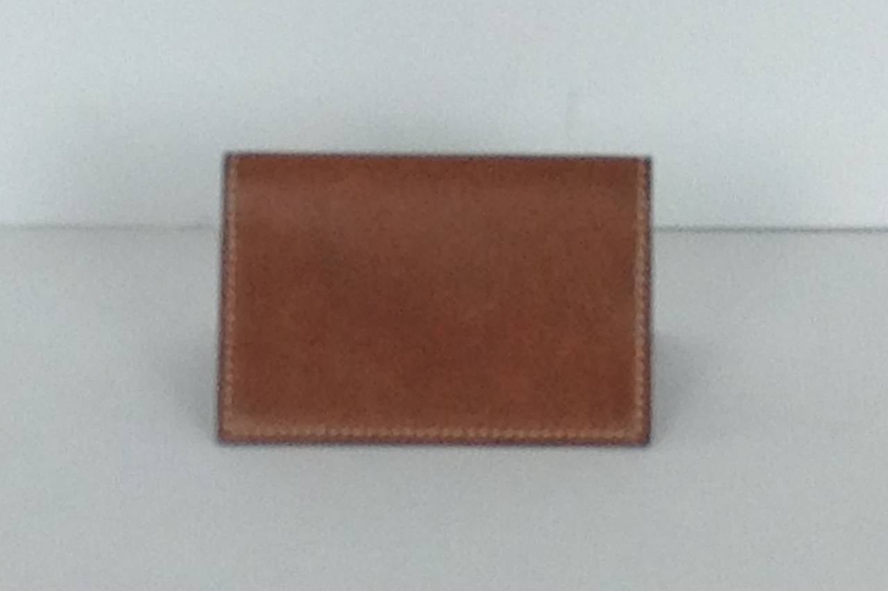 Classy Hermes card holder -excellent for business cards or credit cards.
Opens to reveal 2 slip pockets.  
White top stitching around the perimeter of case.
Natural calfskin.
Minor scratches on the outside.
M stamped in square on the inside-