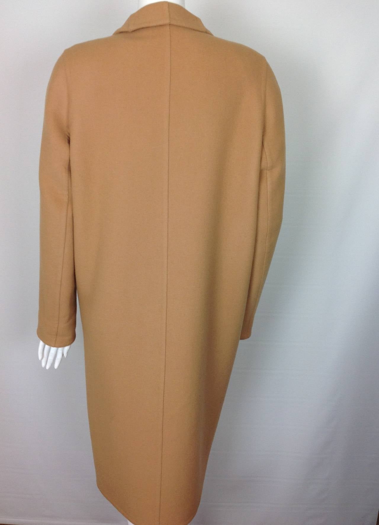 Currently on Hermes website...for $6650!
Double faced Cashmere wrap coat.  Self lined.
Hermes calls it kraft beige, we call it butterscotch...Yummy!
Small tab and button closure inside.  Single rose goldtone metal stud framed by butterscotch
