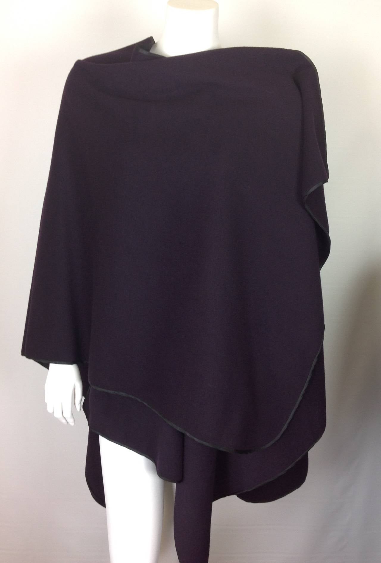 Capas Sesena open short walk poncho.
100% wool, in a most beautiful shade of plum.  Soft not itchy.  
Trimmed in black ribbon.  
Made from a single piece of fabric, no seams. U shaped 30