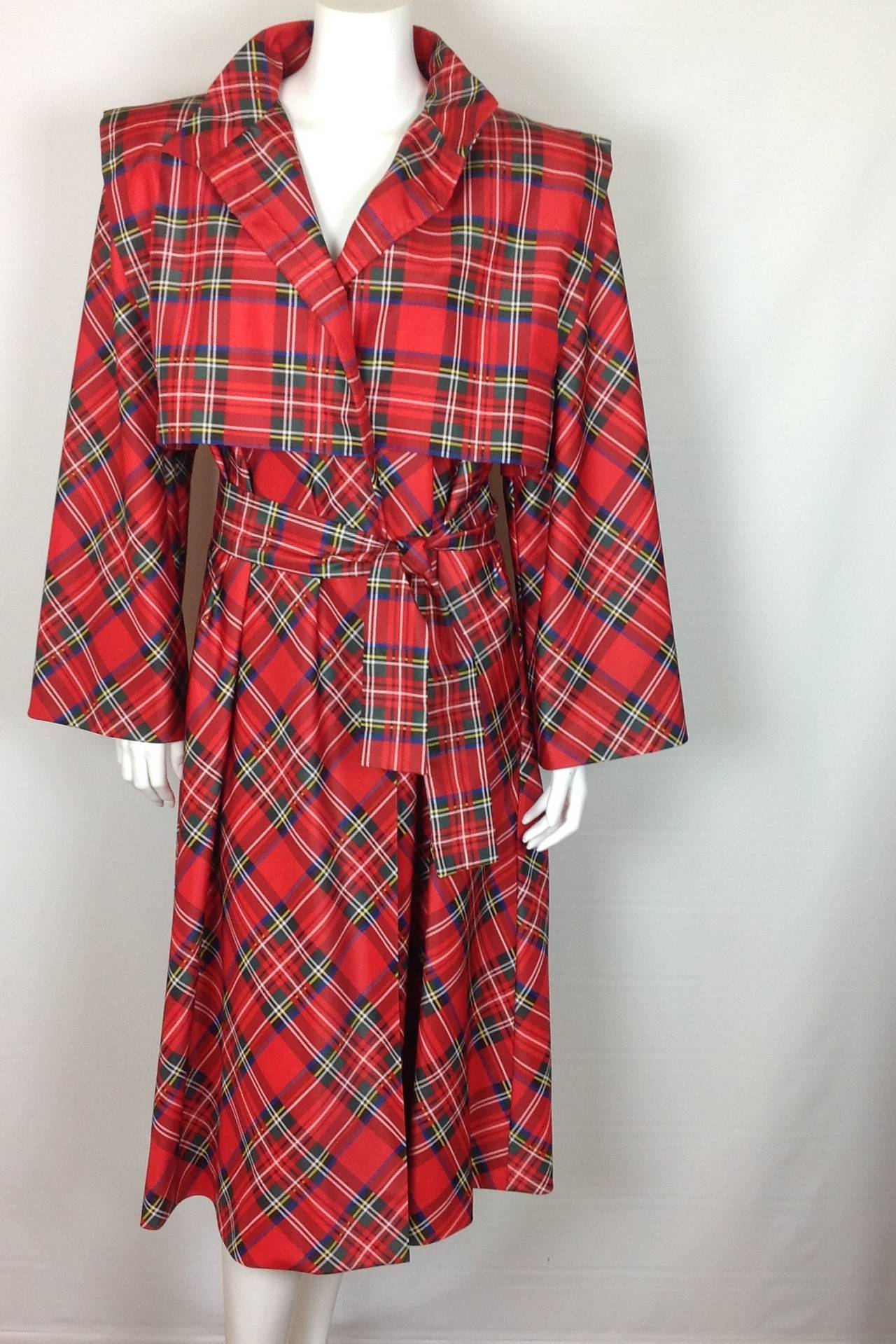 Beautiful plaid raincoat from the 1980's by Pauline Trigere.
2 large buttons, 1 snap closure on the front.
Tartan plaid in primary colors.  Will brighten up any rainy day!
Self belt, and 2 on seam (hidden) pockets. Can be worn with, or without