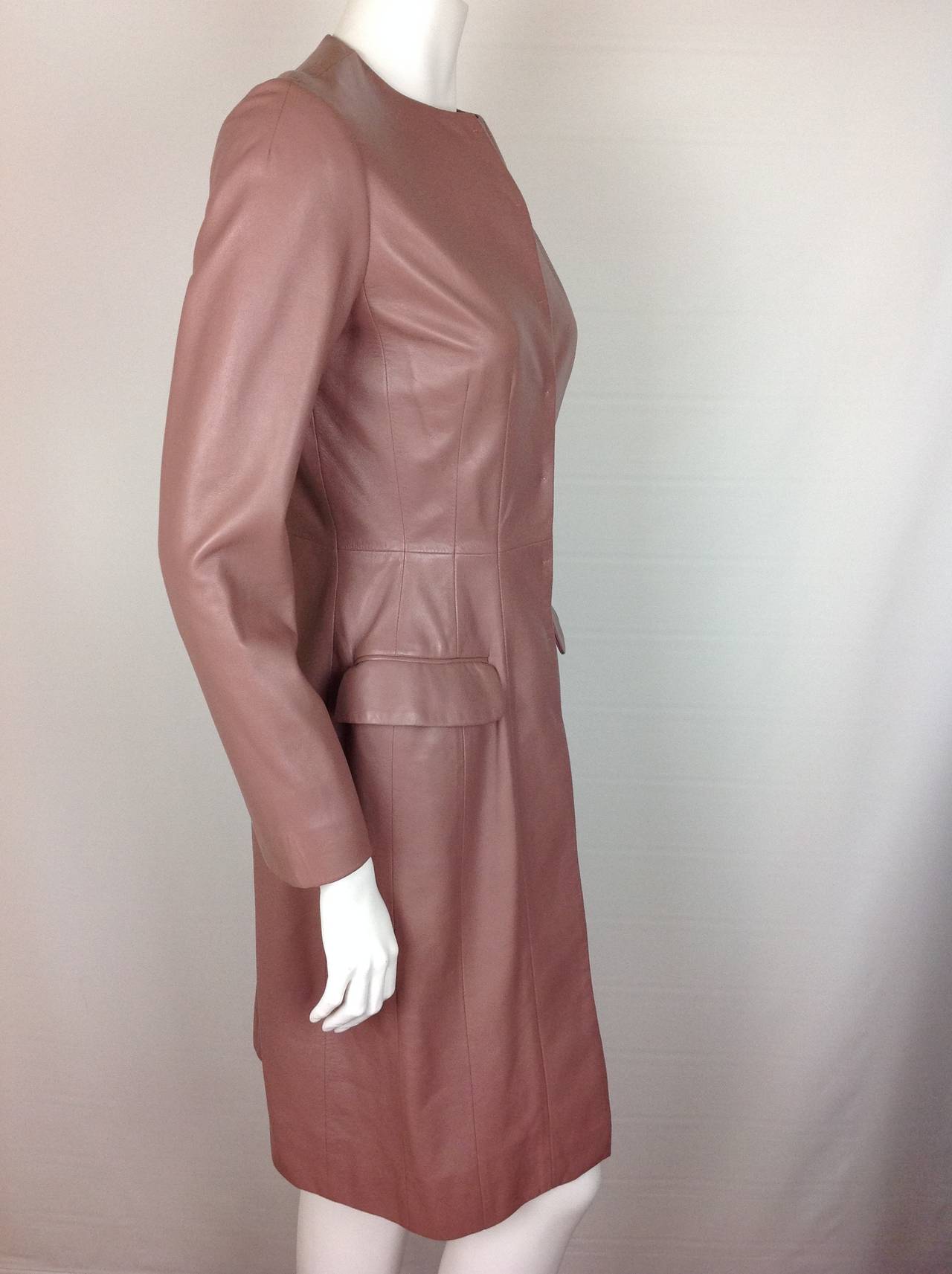 Soft as buttah...Christian Dior mauve lambskin coat/dress.
Beautifully fitted, with 8 hook and eye closures. 2 flap pockets.
Jewel neckline, 15