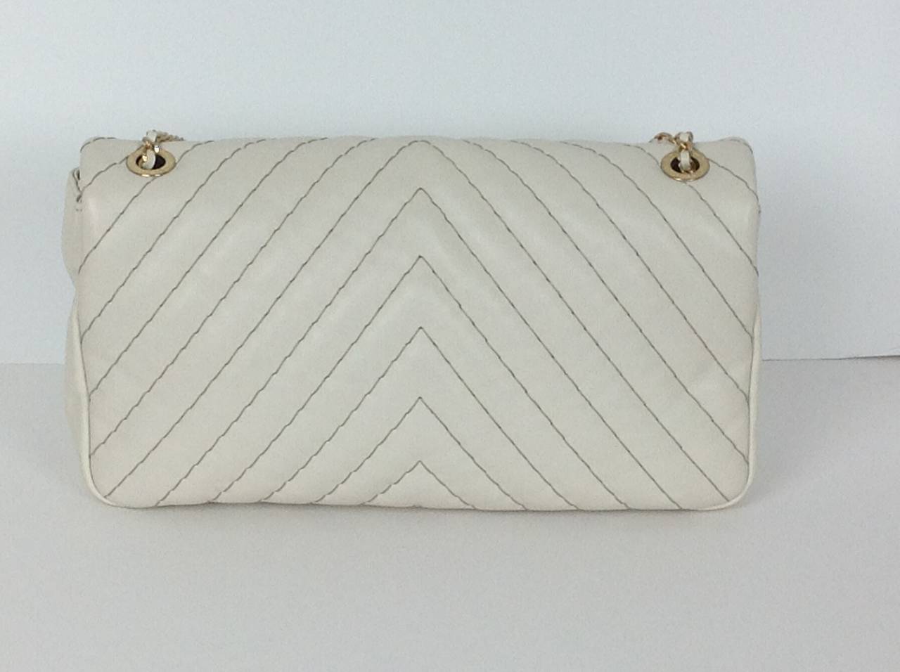 Creamy dreamy Chanel Half Flap Chevron handbag.  Just delicious!
Soft lambskin, chevron quilted with khaki thread. From Spring 2013 collection.
Gold tone mini chain woven with leather.  Chain has 6.38