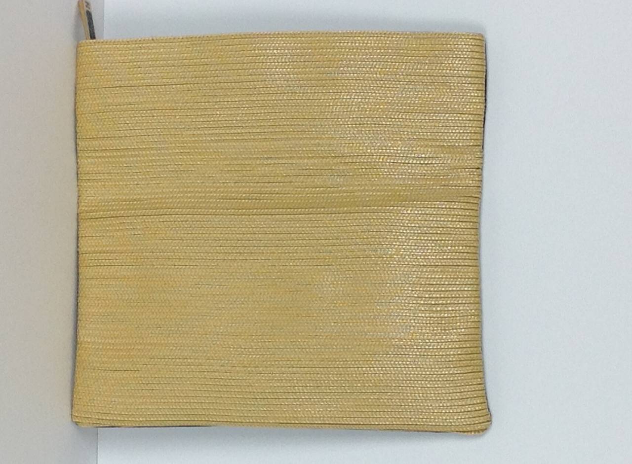 Perfect for summer, bi-color Fendi Chameleon straw clutch.
Herringbone patterned straw;yellow/gold on one side, polished black on the other.  12.50