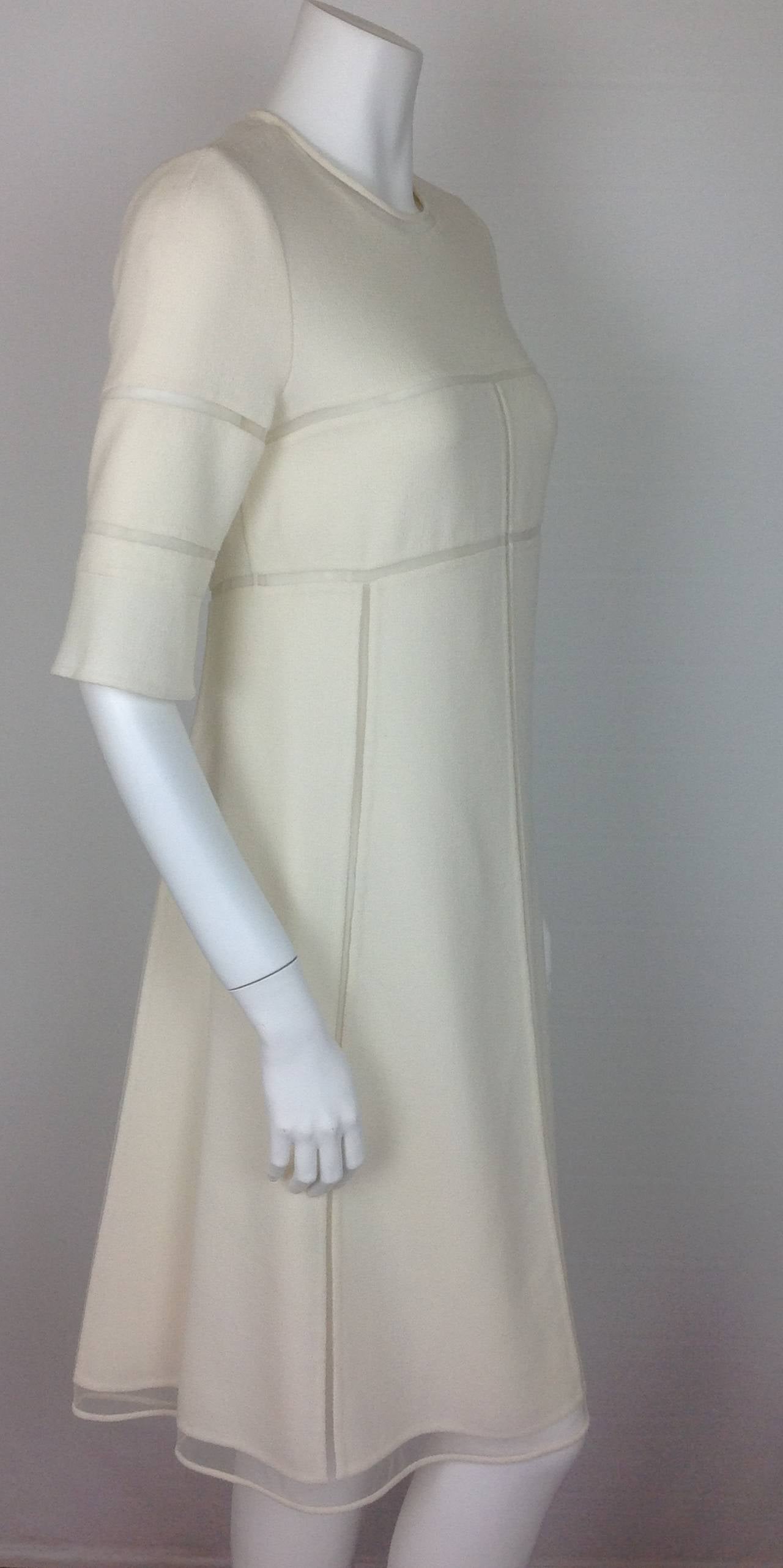 Gorgeous heavyweight crepe cream Ralph Rucci for Chado dress.
Tulle insets highlight the neckline, hemline and around the bust and sleeves.
Tulle insets, a recurring theme in Mr Rucci's designs, reveals the bodys movement. Th dress is fully lined