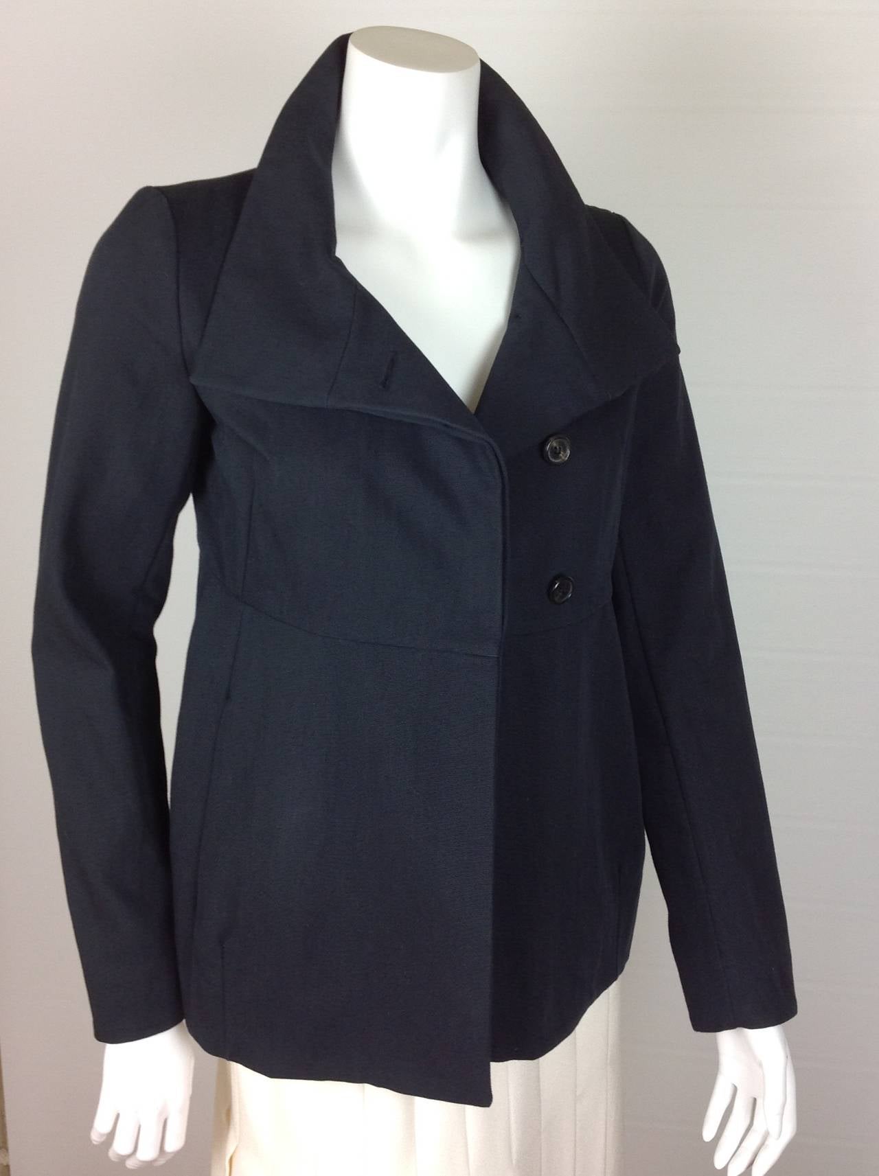 Lovely navy Marni jacket - an updated version of a navy blazer.  
60% cotton 40% nylon, looks and feels like a heavyweight cotton. Has body & shape, not a flimsy cotton.
3 horn button closure, 2 on seam pockets on the front.  The 3 buttons are