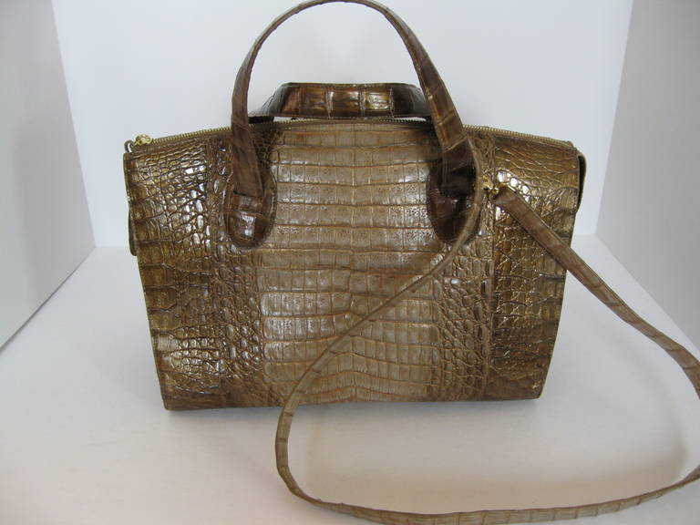 Ombred metallic crocodile Nancy Gonzales satchel.  High gloss finish.  
Lined in suede, 1 zippered pocket, 1 cellphone pocket, 2 open pockets inside.
For security purposes there is an 18