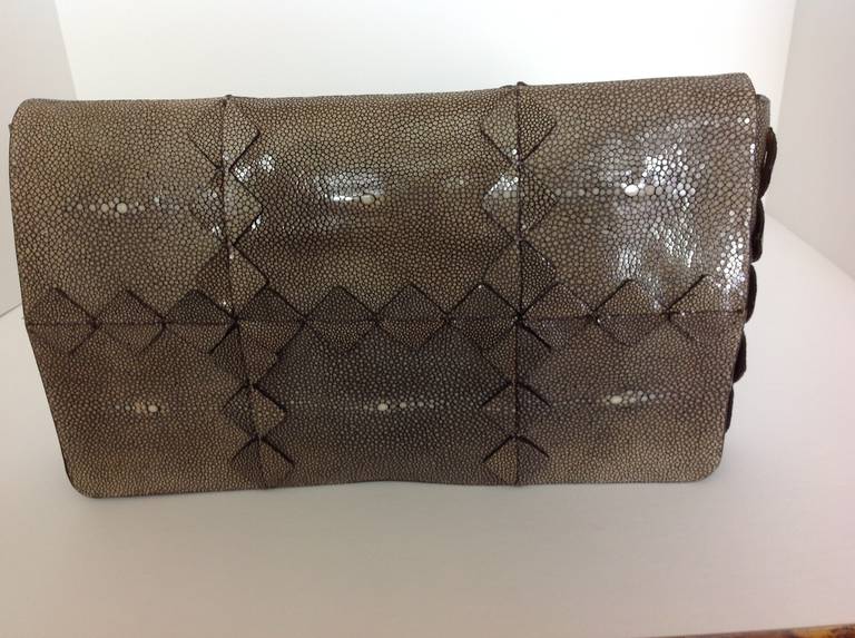 3D Salvatore Ferragamo shagreen/stingray Clutch. Hi glaze finish.
Diamonds cut from the stingray and reapplied in a grid pattern, all over.
Cream, tan, gray and black stingray makes for a sophisticated neutral bag.
Lined in tan calfskin leather. 