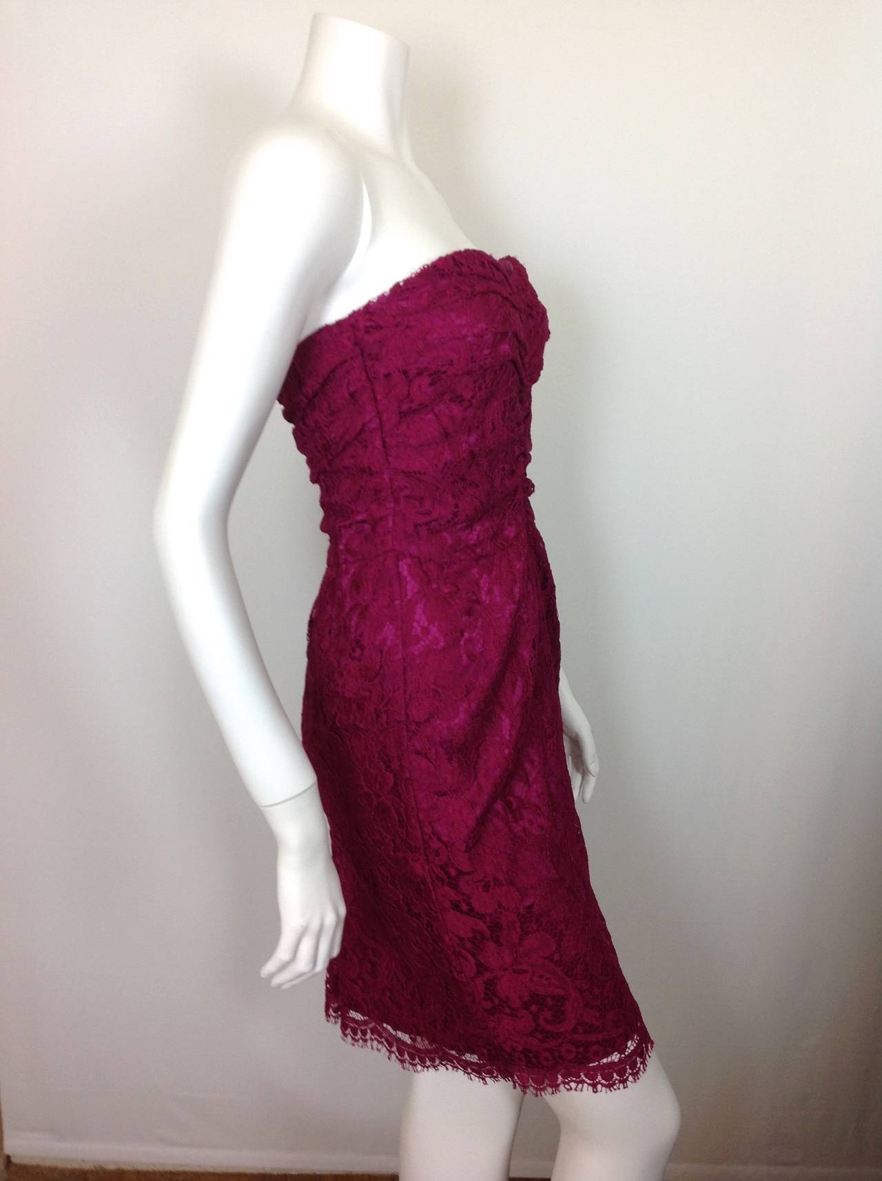 Fuchsia strapless lace Dolce & Gabbana dress.  
Made in Italy of soft lace.  75% cotton, 25% poliamida.
Lined in 96% silk 4% elastane, with a boned, longline padded bra.
13 1/2