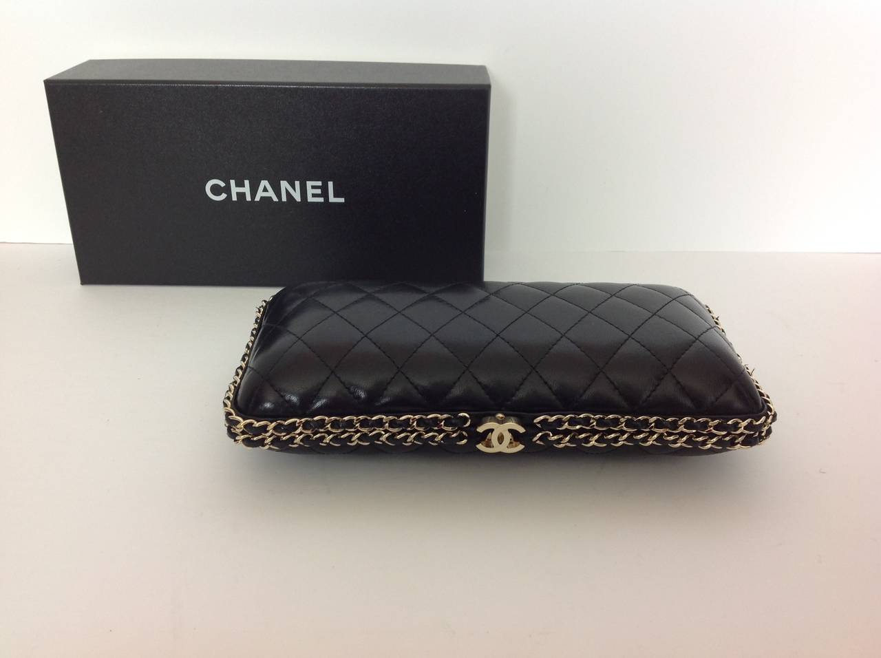 Hard CHANEL black clutch bag.  Excellent condition.  
Diamond quilted pattern in leather.  Double CC clasp.
Trimmed with double row mini gold chain interwoven with leather.
Hidden gold chain with inter woven leather  23