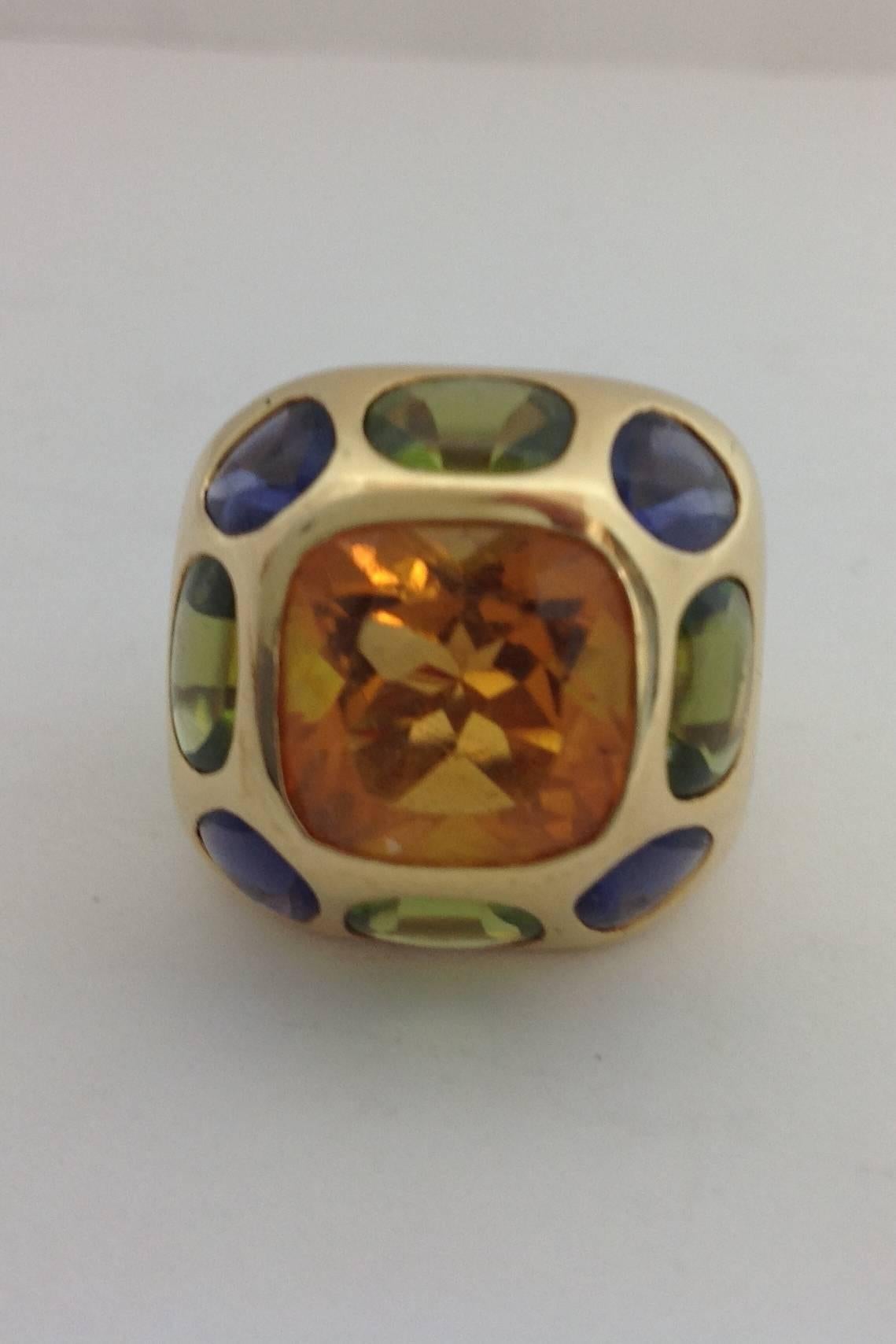 18K gold Chanel ring from the Baroque Collection.
Center stone 12mm X 12mm Citrine.
4 Cabochon 5mm X 7.5mm oval peridot.
4 5mm X 6mm oval iolites. 
.86