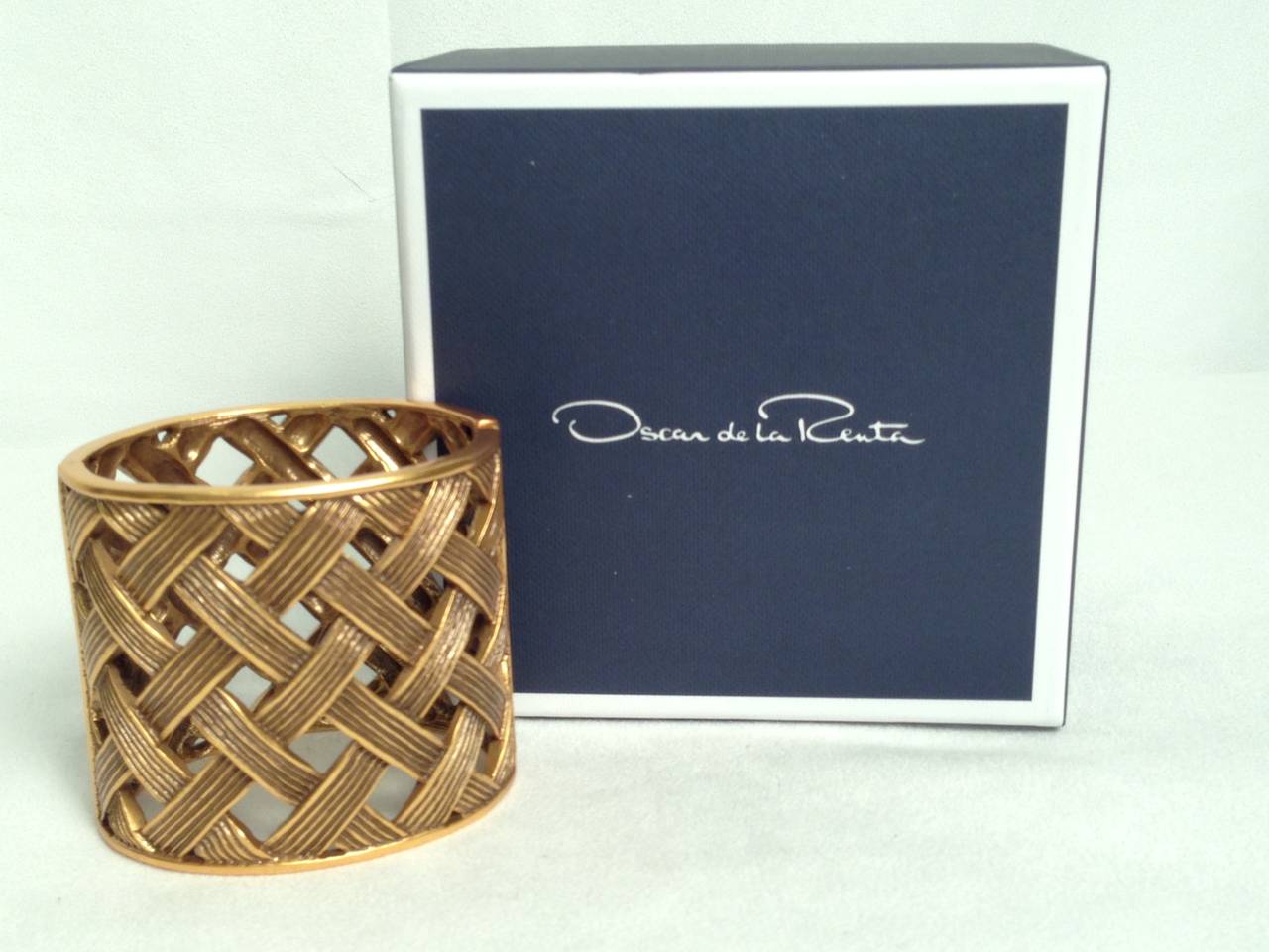 The intricate brass basketweave motif of this Oscar de la Renta cuff emboldens your look with its architectural, geometric shape! Perfect for 3/4 sleeves, oval shape provides comfortable, secure fit.  Diameter:  2.5