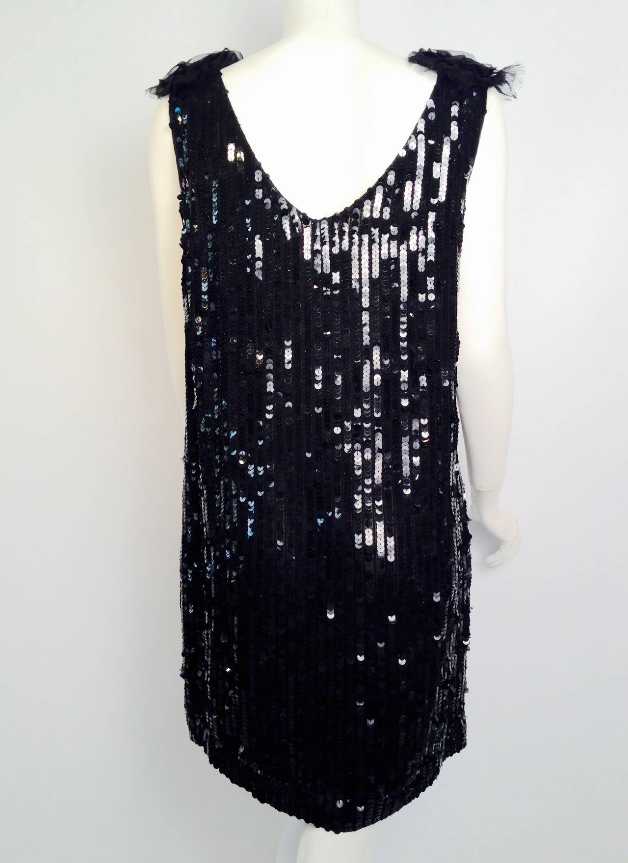 Luxurious black sequins and exquisite beading evoke the Jazz Age in this sleeveless shift dress by the British design duo Georgina Chapman and Keren Craig.   You'll find yourself doing 