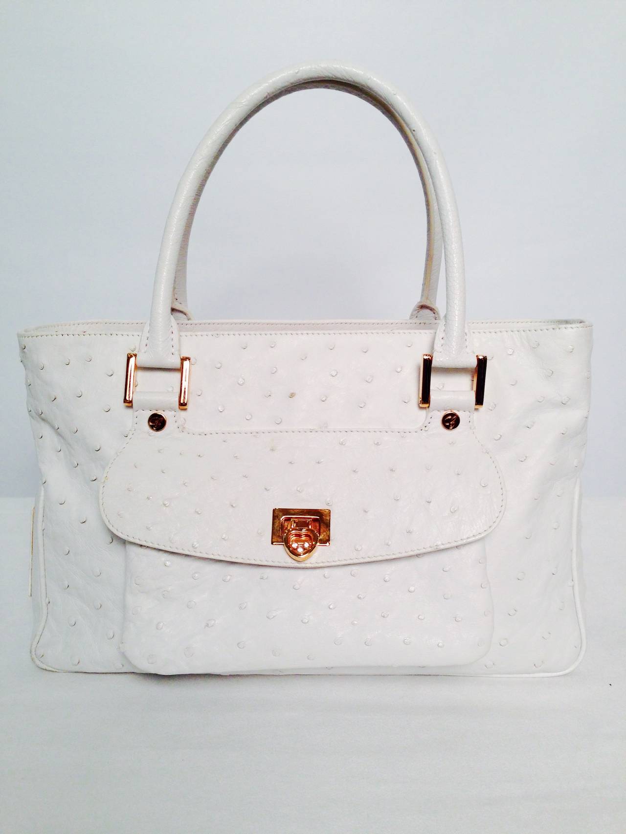 Chopard White Ostrich Satchel proves that this venerable Swiss company makes more than just exquisite watches!  Luxurious ostrich is used to create a satchel fit for a lady.  Features four internal compartments - two internal pockets are zippered. 