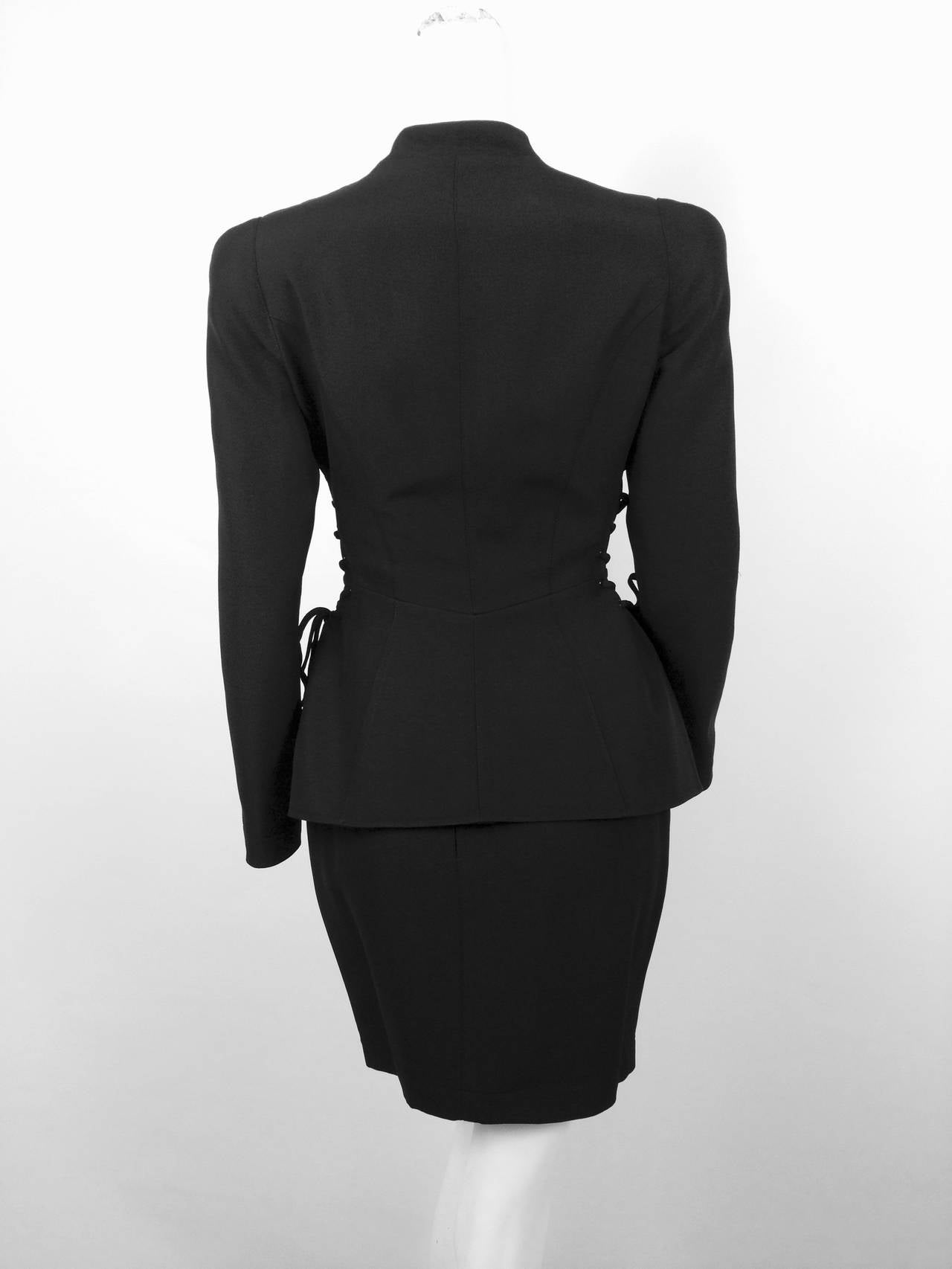 Relive the voluptuous silhouettes of the late 80's and early 90's in this vintage Thierry Mugler black skirt suit with corseted jacket!  The look says it all...