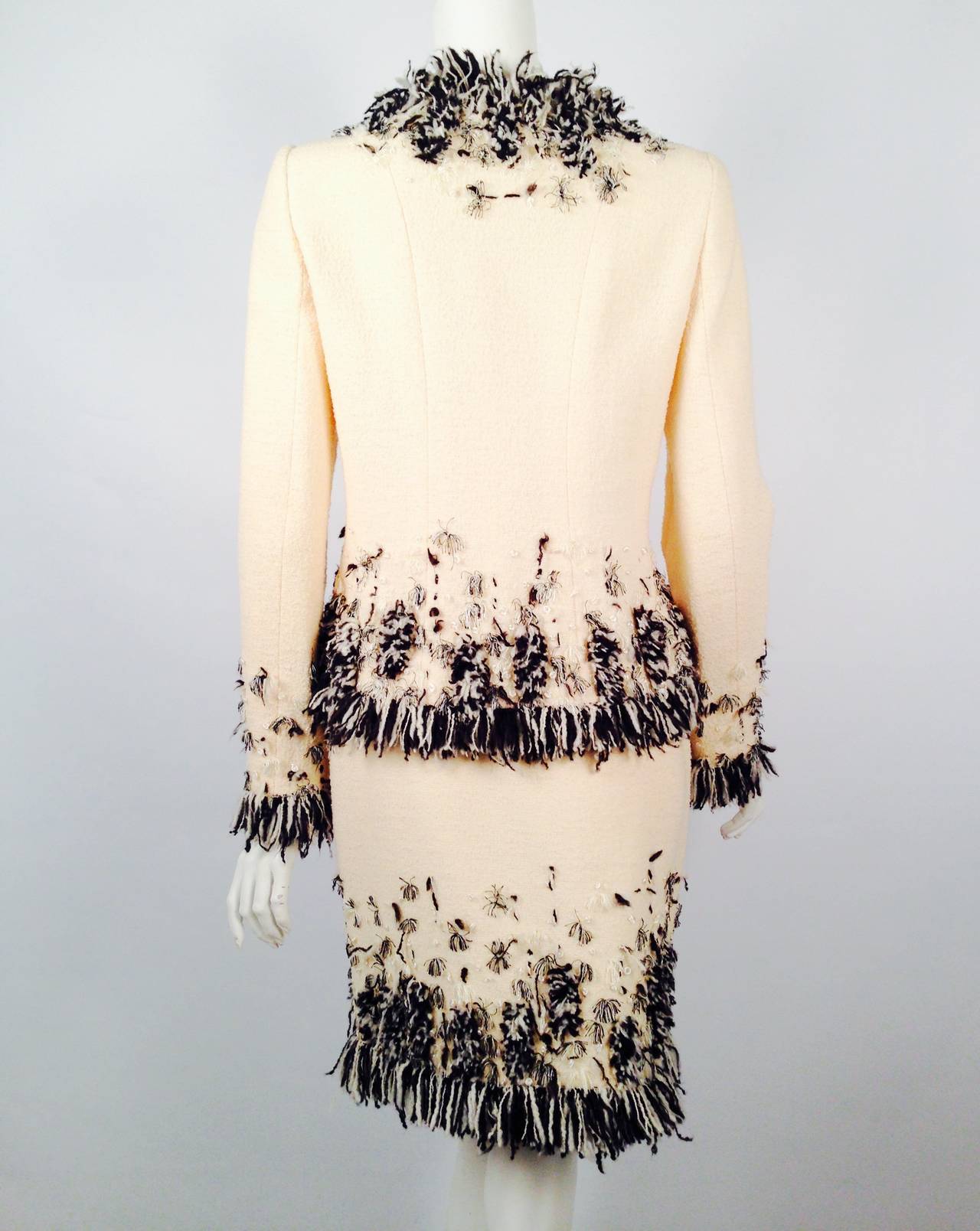 Oscar de la Renta Wool Boucle Yarn Embroidered Skirt Suit celebrates the couturier's passion for fashion.  Only the finest French Vanilla wool boucle would do!  Collarless jacket features two pockets, and one hook and eye closure.  Straight skirt