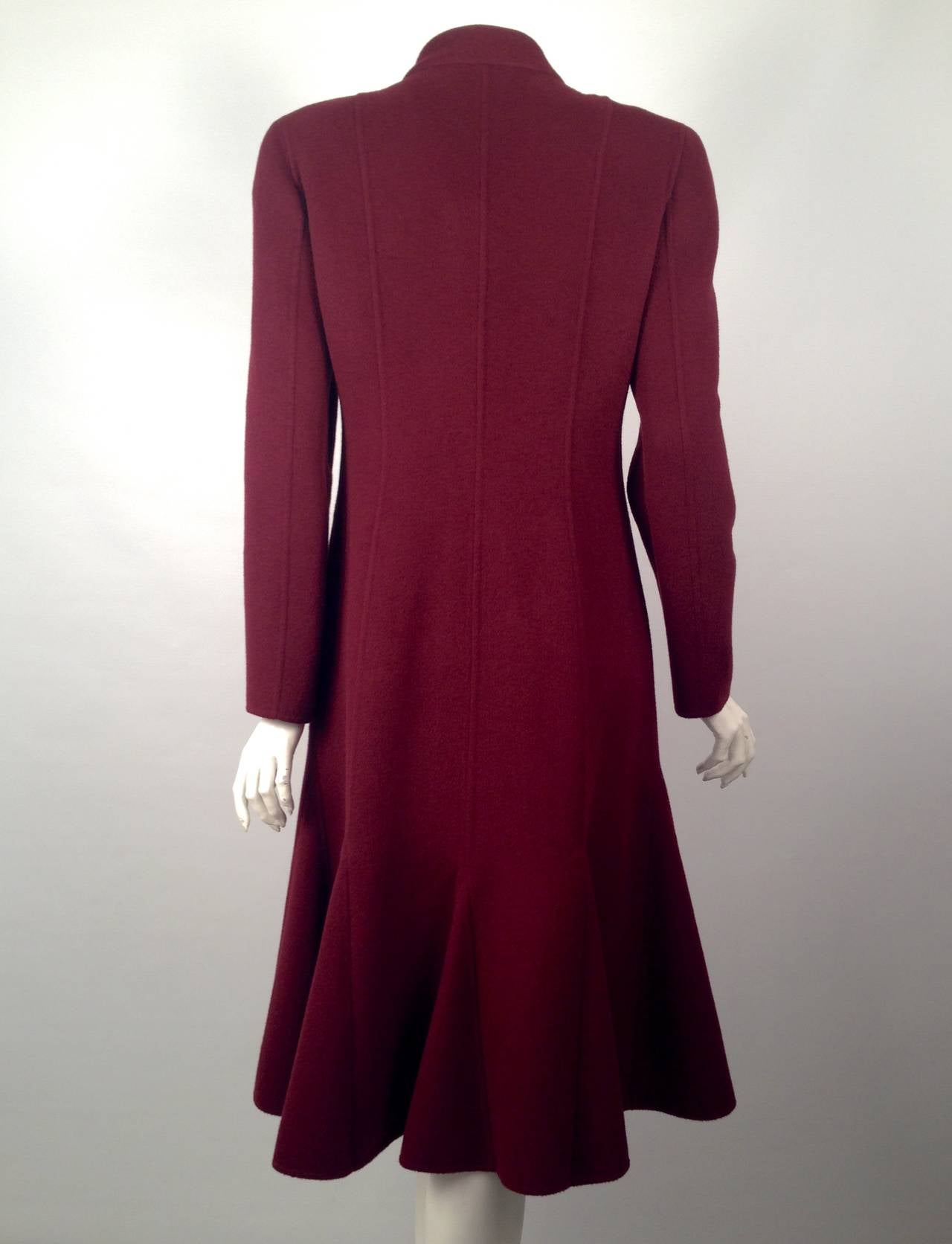 Valentino Burgundy Wool and Cashgora Coat With Godet Hemline illustrates an haute couturier's passion for detail!  Only the finest wool and cashgora blend would suffice.  Features include stand up collar and a five-button closure elegantly concealed