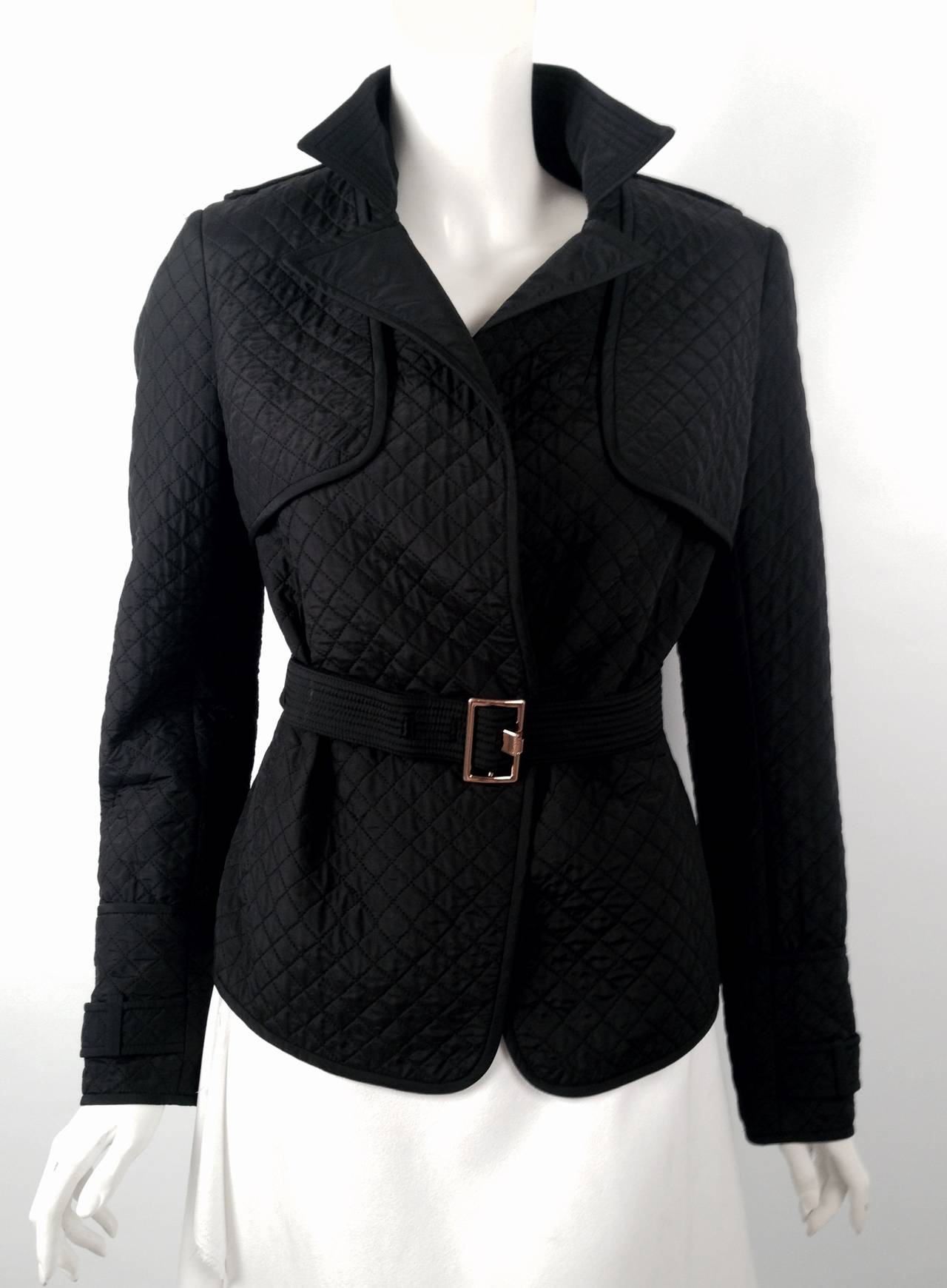 Yves Saint Laurent Diamond Quilted Jacket is the perfect companion when exploring the Left Bank.  Features include luxurious, water-repellant fabric, epaulets, belted waist, and sleeve straps.  Storm patches and rear vent make this coat functional