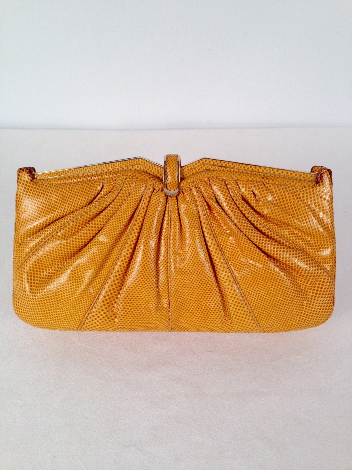 Vintage Yellow Lizard Convertible Clutch is highly desired by all collectors of Judith Leiber! Features slightly gathered, butter-soft lizard skin.  Bag easily converts from clutch to shoulder bag with minimal effort!  Forgiving gusset accommodates