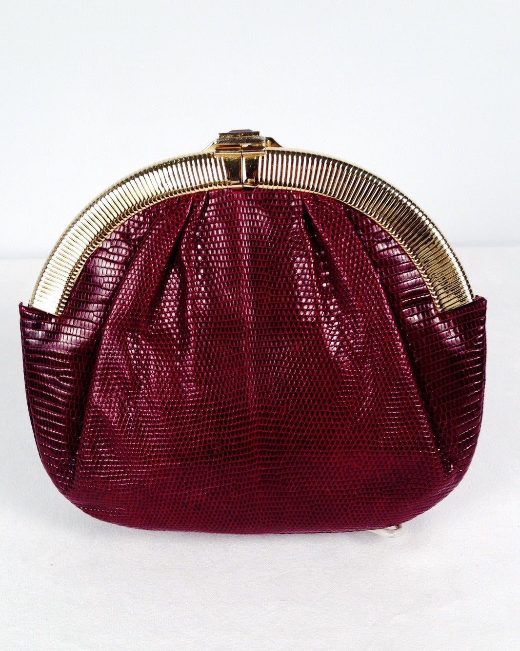 Vintage Burgundy Lizard Evening Bag is highly desired by all collectors of Judith Leiber! Features slightly gathered, butter-soft lizard skin. Bag easily converts from clutch to shoulder bag with minimal effort! Forgiving gusset accommodates more