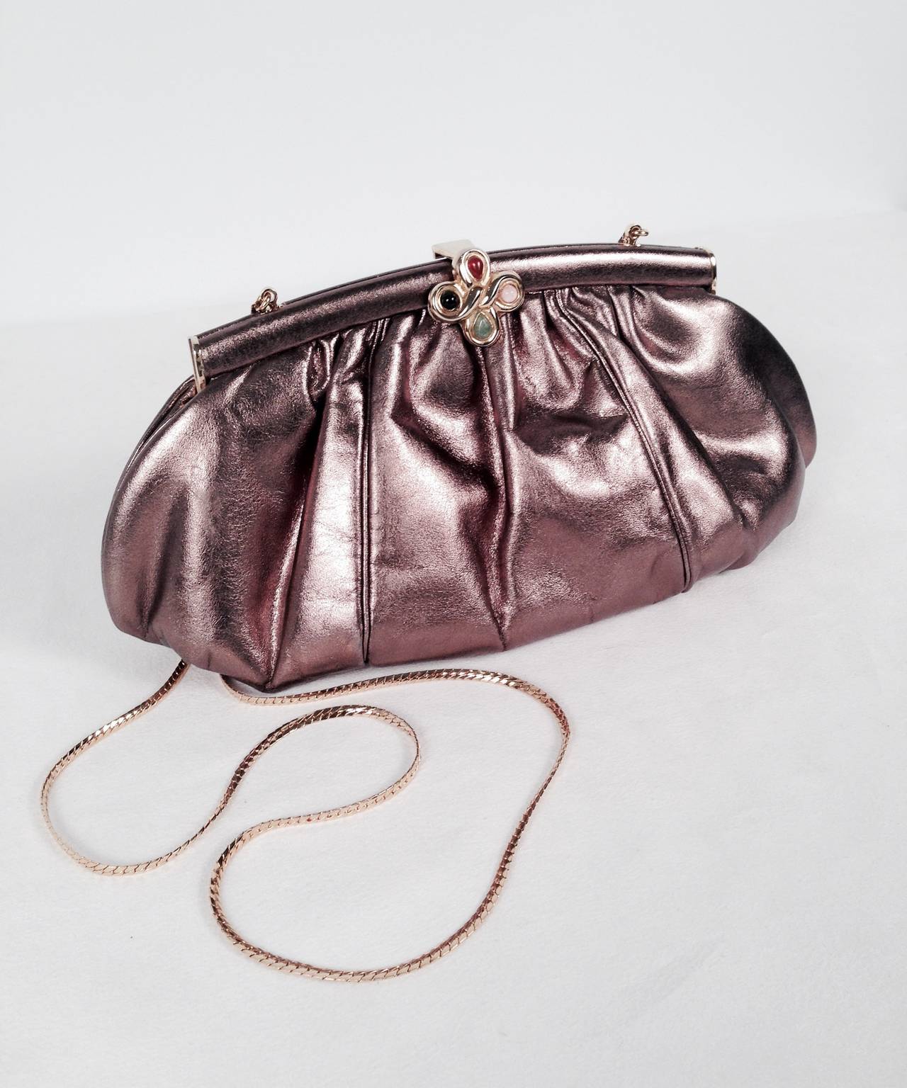 Vintage Metallic Leather Evening Bag With Jeweled Clasp is highly desired by all collectors of Judith Leiber!  Features butter-soft iridescent leather that is slightly gathered and changes from pink to bronze to gold in different light.  Converts