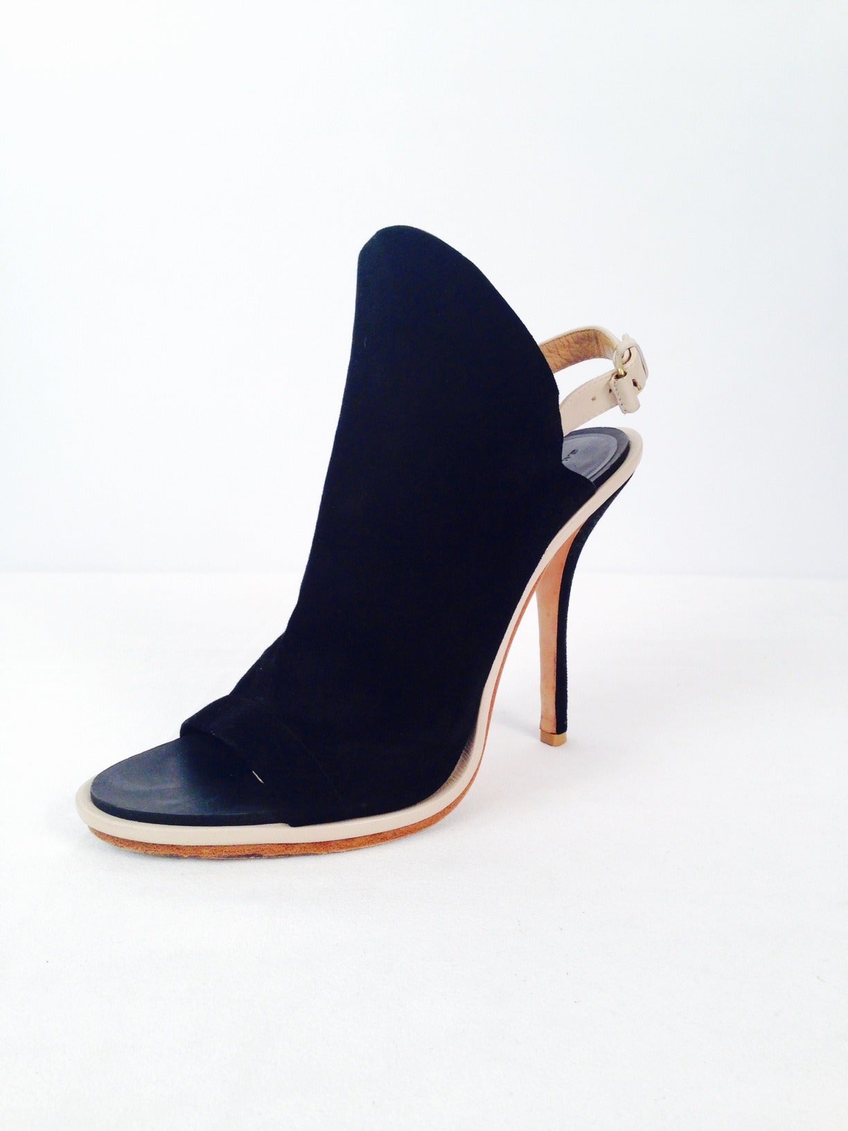 Black Suede Peep Toe Sling Backs remain true to the design philosophy of one of fashion's most celebrated couturiers, Cristobal Balenciaga.  Fashion-forward, yet elegant, shoes feature supple black suede vamps and black suede covered high heels. 