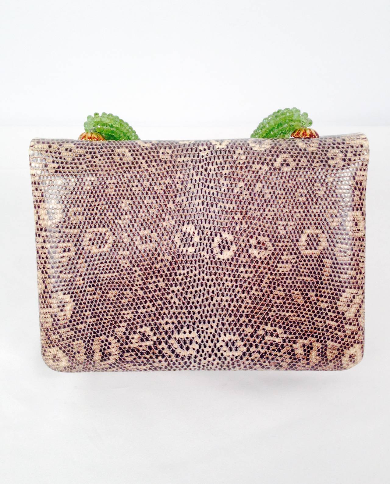 Darby Scott Lizard Evening Bag With Peridot Strands is an excellent example of luxurious craftsmanship.  Evening bag offers supple black and white lizard exterior with smooth beige leather interior.  One interior flat convenience pocket lined in