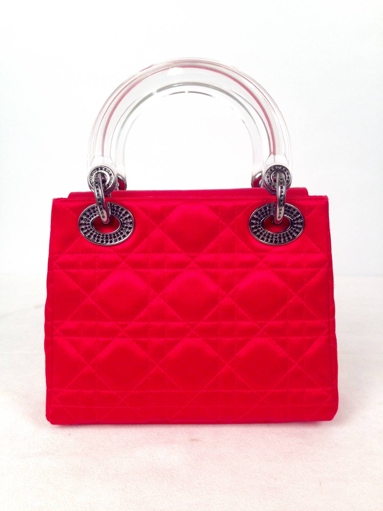 The Lady in RED!  Named for Lady Diana, this iconic Christian Dior bag is crafted from quilted red satin and is accented with black Swarovski crystal embellished 