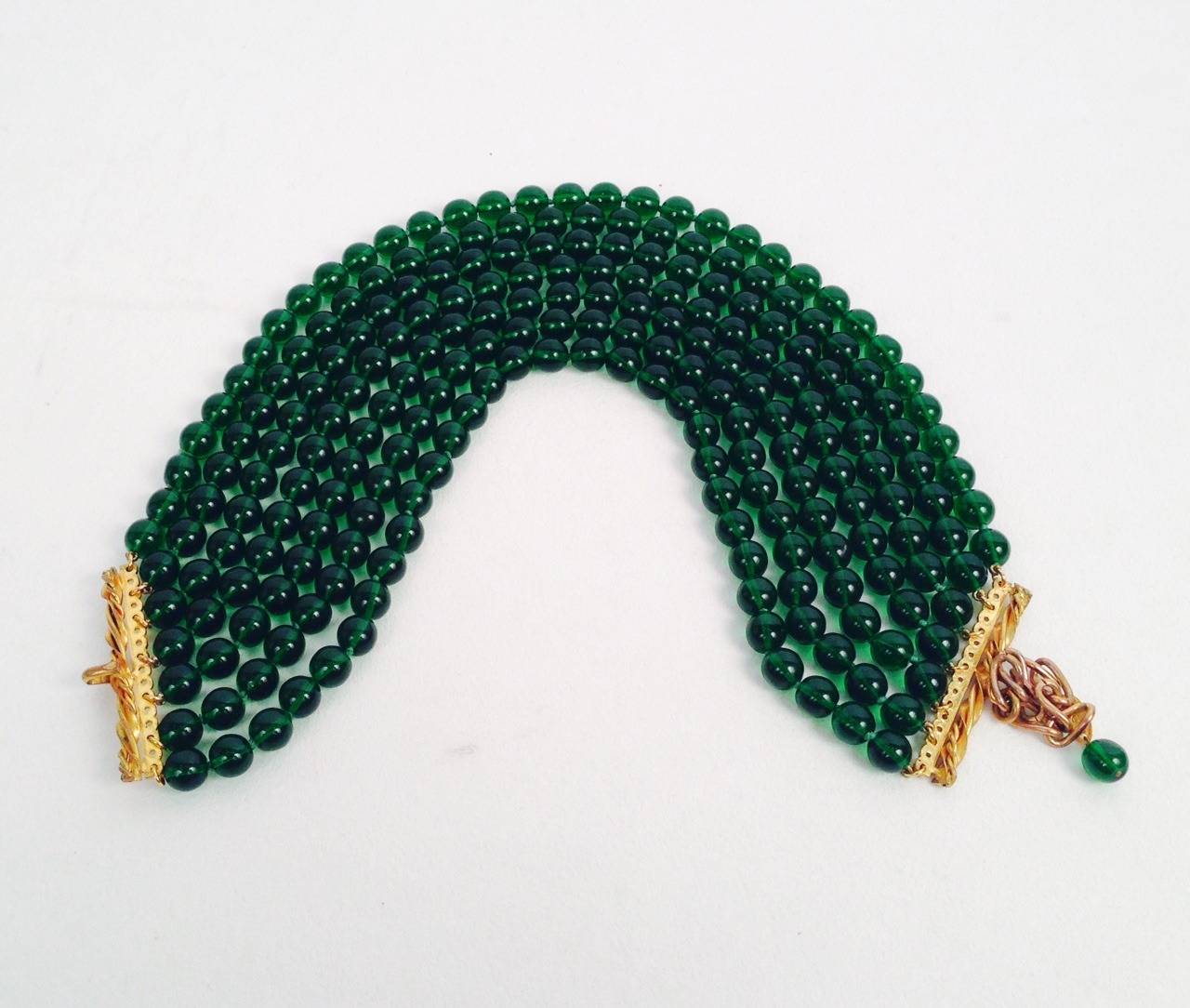 Vintage Chanel Gripoix Green Glass Bead 7 Strand Torsade is unique!  Rare necklace pays homage to Chanel's love of versatility.  Perfect for day or night, emerald green beads may be worn as a torsade or untwisted.  Either way, necklace is