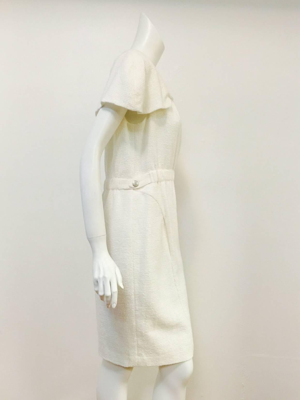 Chanel Ivory Cotton Dress pays homage to the design aesthetic of Coco herself!  Comfortable?  Chic?  But of course!   Dress features signature cotton tweed fabric, round neckline, banded waist and slightly above the knee length.   Dolman capped