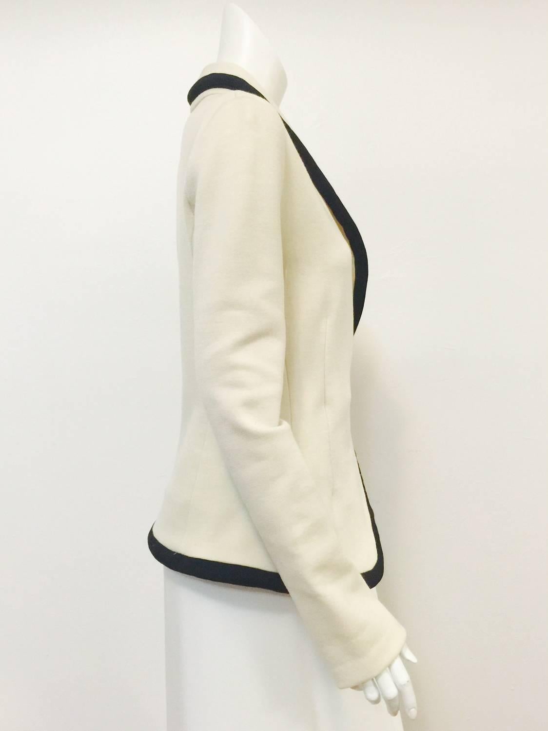 Balenciaga Fitted Ivory Wool Jersey Jacket is a bold design reminiscent of sweaters worn by collegiate varsity athletes.  Features exquisite fabric with just the right amount of stretch, shawl collar, offset snap closure and asymmetric hem.  Single