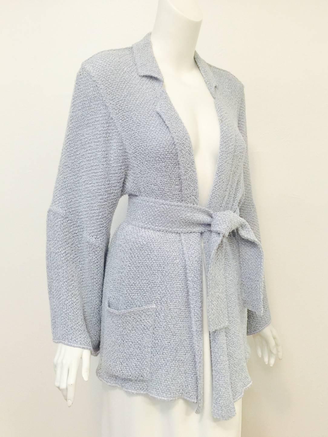 Chanel Boutique Powder Blue Cotton Belted Cardigan pays homage to Coco's revolutionary designs of the 1920's!  Features exquisitely luxurious cotton fabric,  daringly comfortable unconstructed silhouette, and a generous sleeves.  Notch collar, belt