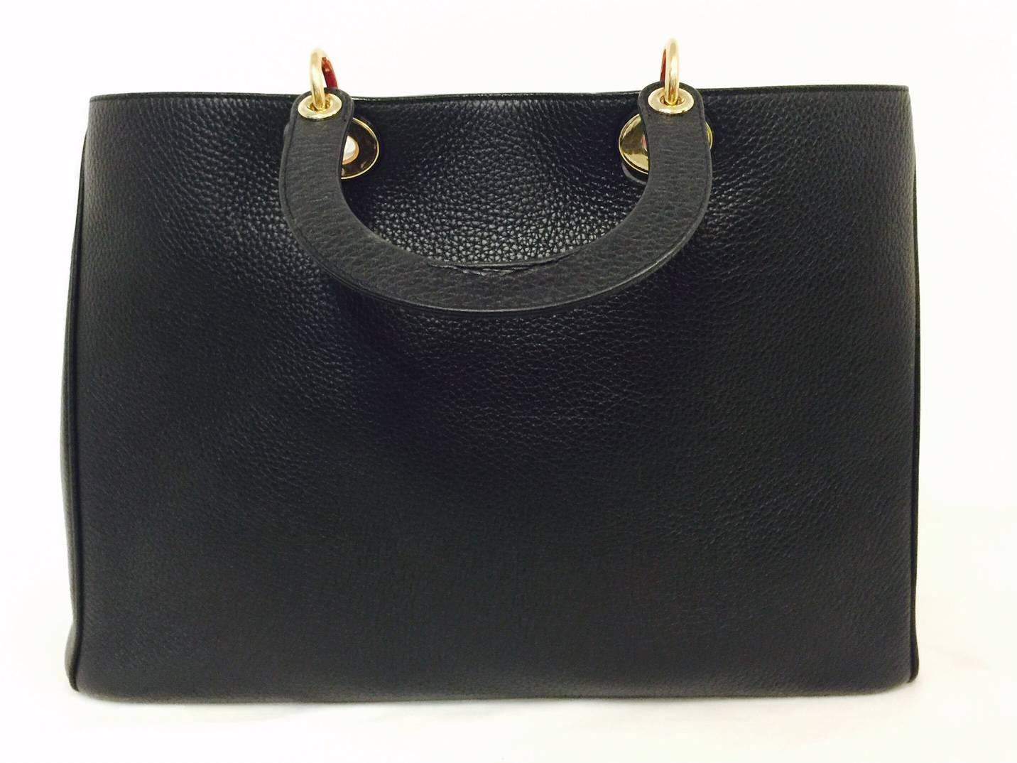 An instant classic and coveted around the globe, this black large Diorissimo is in Way Above Excellent to New Condition!  Exquisitely crafted from luxuriously grained bull calfskin leather, bag features duo black rolled leather top handles with