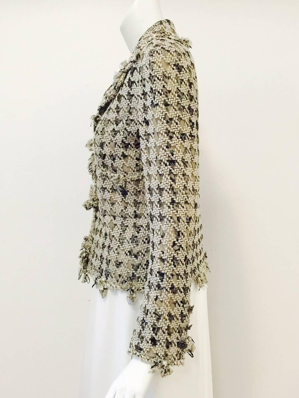 Chanel 2005 Cruise Collection Jacket With Net Overlay is worthy of any collection celebrating all things Coco!  As one would expect, elevated craftsmanship abounds. Features signature black and tan coloration, notch collar, two patch pockets and
