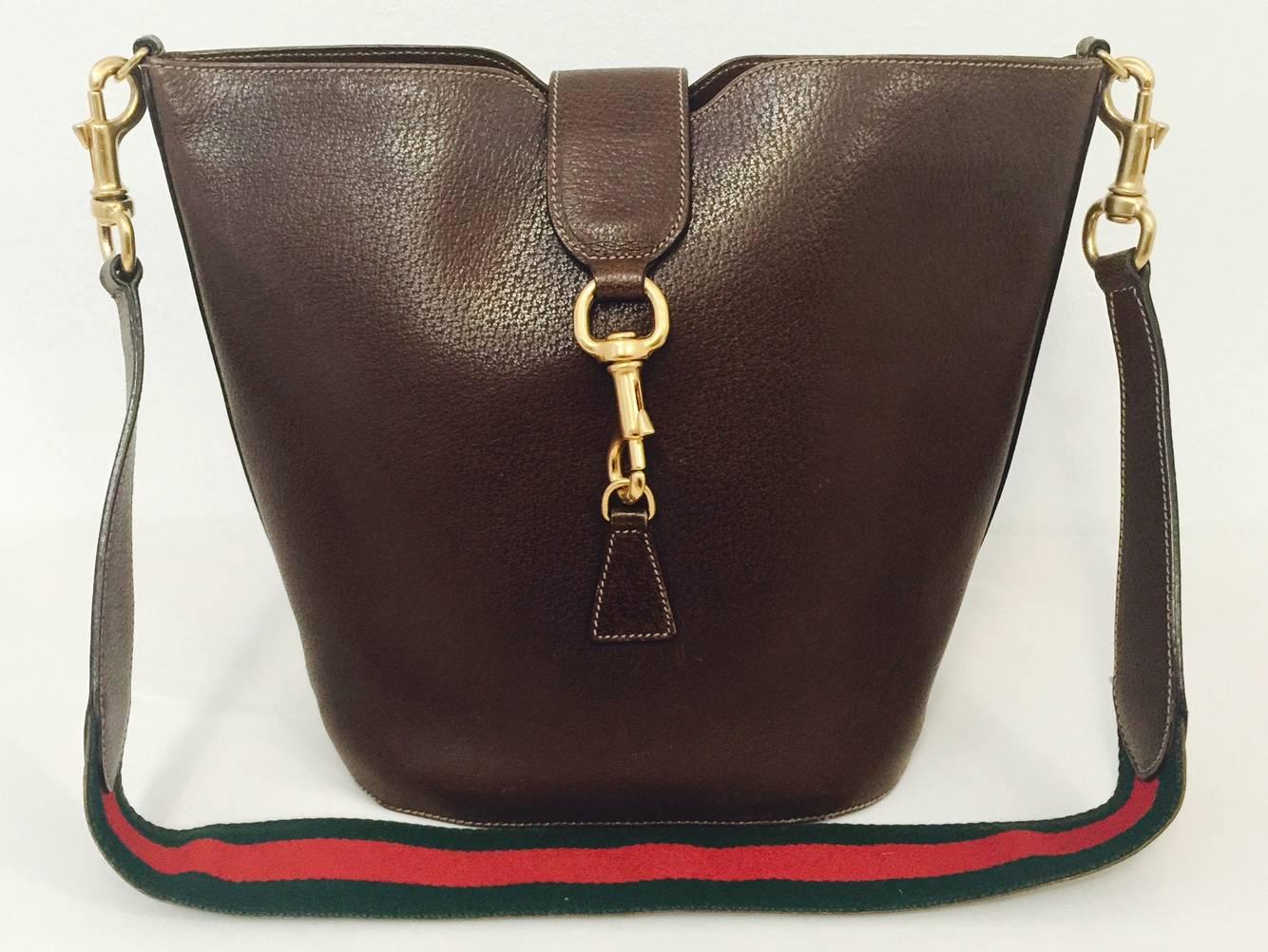 Vintage Leather Brown Bucket Bag is a must for collectors of finely crafted handbags in general and Gucci in particular!  NOTE:  Bag is all leather...and features substantial brass hardware and signature green-red-green striped web shoulder strap