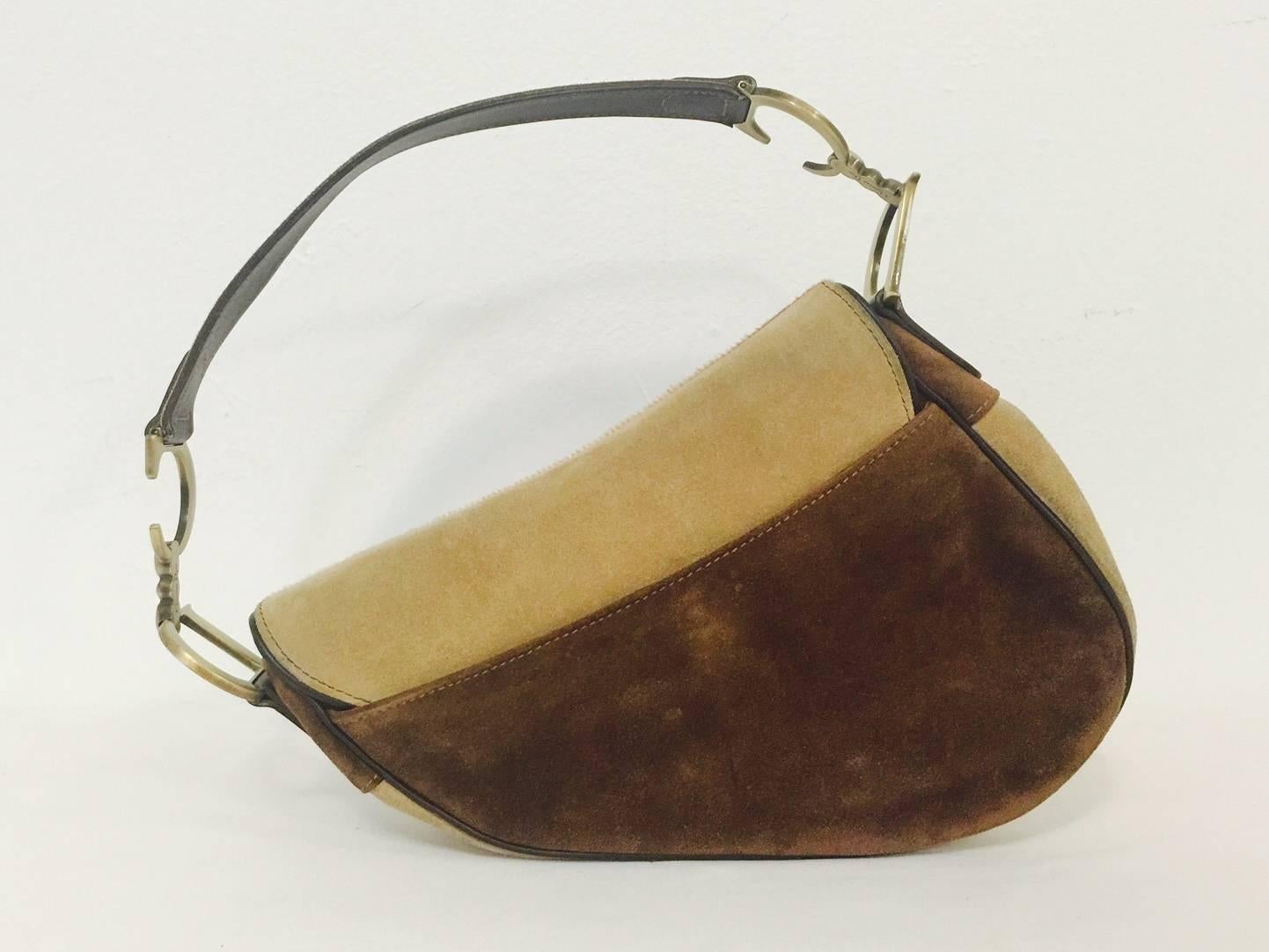 Since it's introduction in the late 1990s, Christian Dior's Saddle Bag has become an iconic accessory coveted by socialites and celebrities alike.  Features the now renown design fashioned in luxurious chocolate, toffee and tan calf hair.  Signature