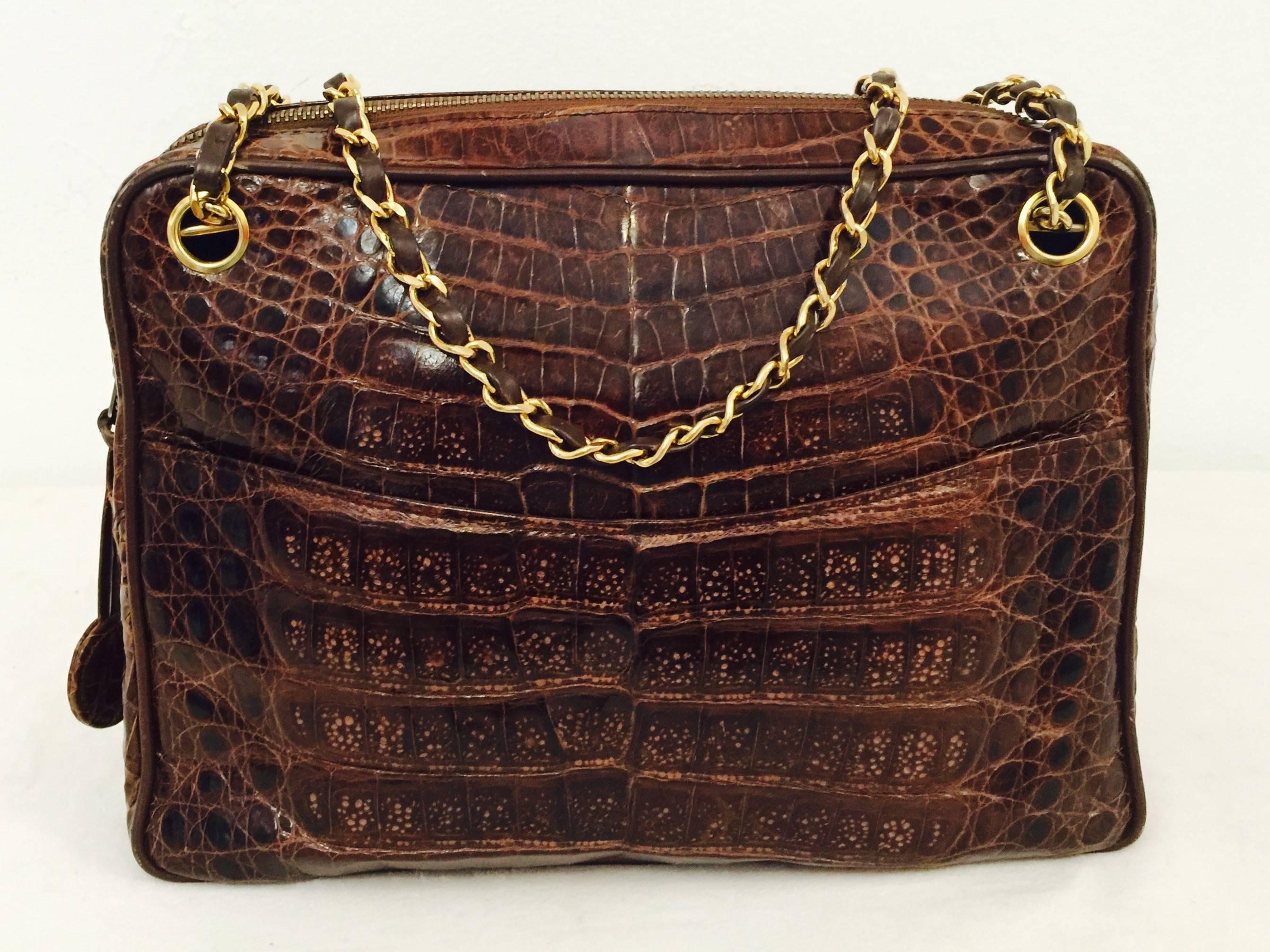 The gold chains say it all...undeniably Chanel! Live the fantasy with this quintessential and most luxurious bag in timeless crocodile. Two convenient exterior pockets and two interior zippered pockets. Additional interior accessories open pocket