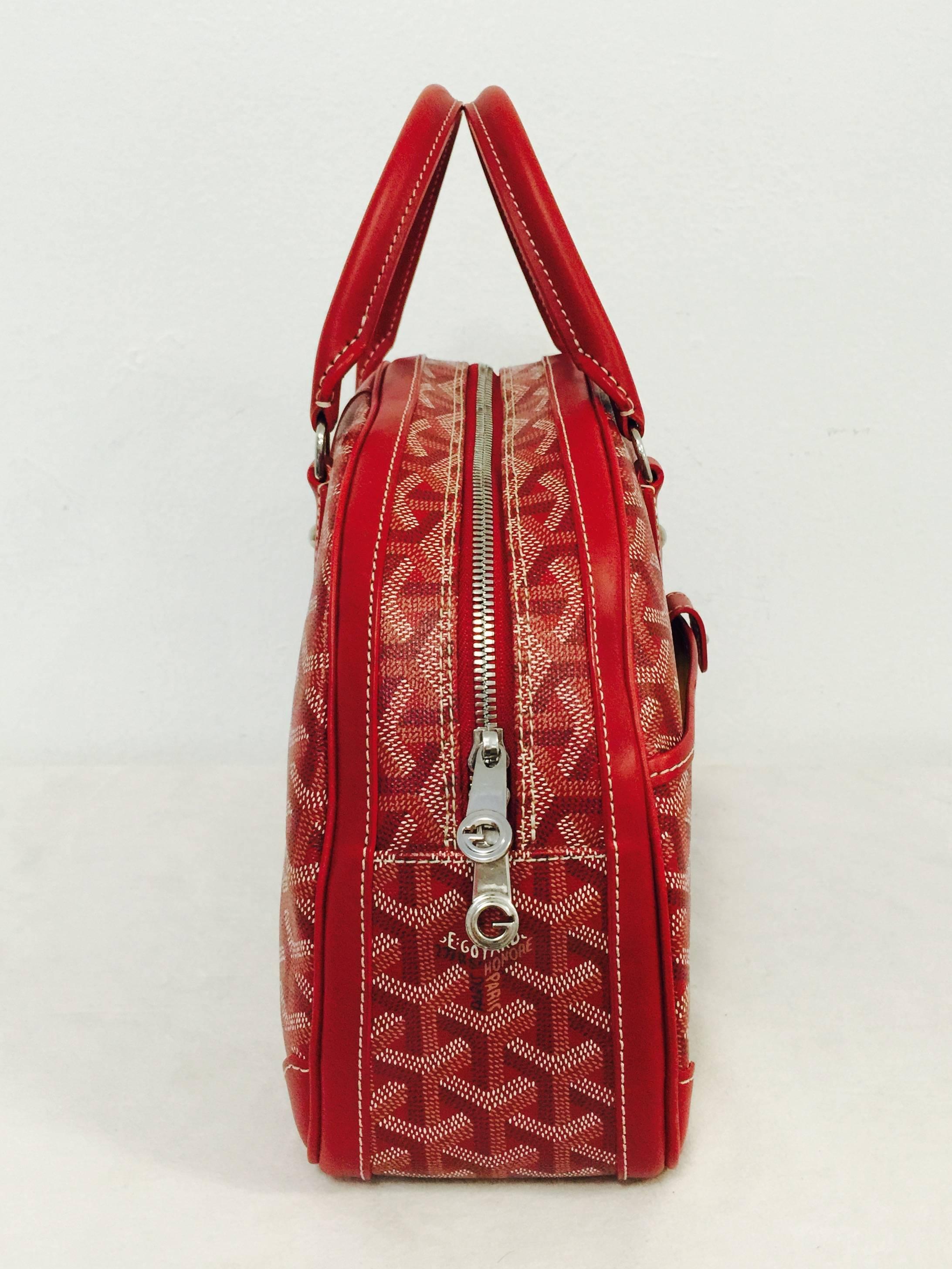  Goyard Red Saint St. Jeanne MM Bowler is a must for all enthusiasts of this legendary French house!  The bag features rolled leather top handles and other leather trim and polished silver hardware. This opens to a mango orange fabric interior that