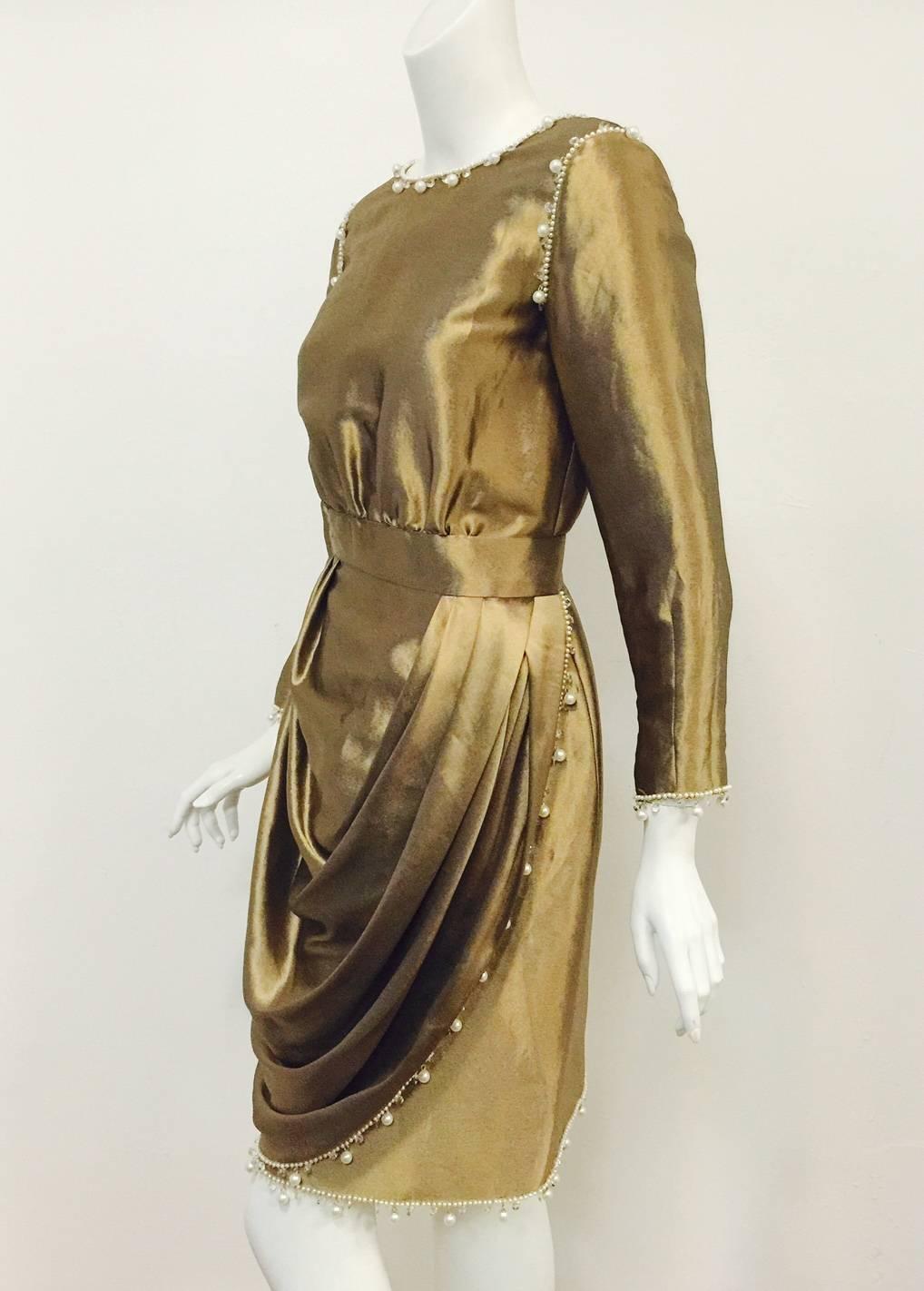 This confection proves that Coco inspired designer Karl Lagerfeld to create more than mere tweed day skirt suits and quilted leather handbags!  Crafted from an unbelievable mixture of metal, silk, and a a kiss of polyester, this Antique Gold