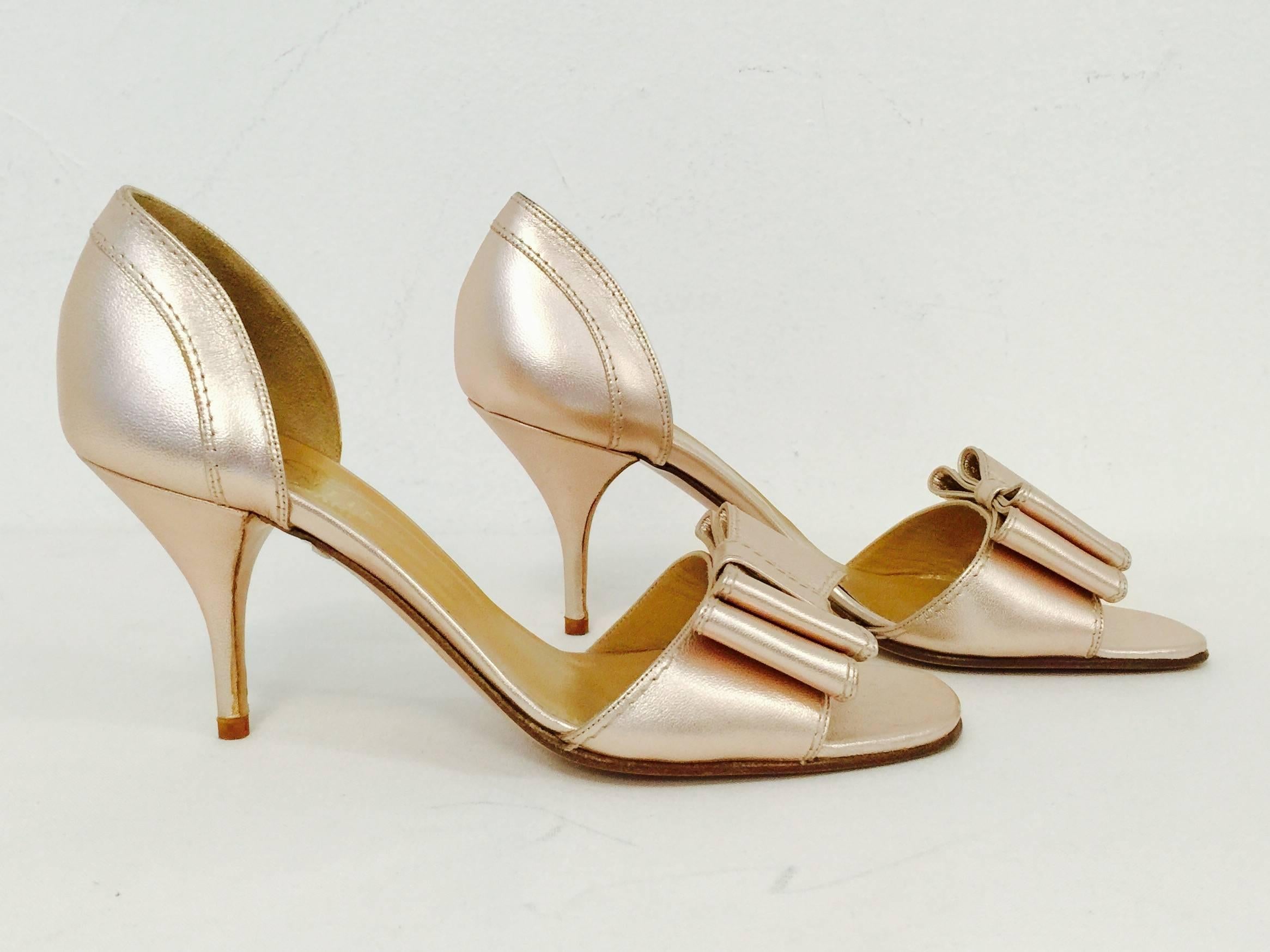 Valentino Garavani High Heels are pure Valentino...feminine, flirty, and fabulous!  Crafted from supple rose gold metallic leather, sandals feature leather soles and insoles with suede lined counters.  Finished with Valentino's signature bow on the